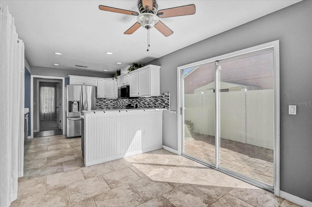 Dinette Looking into Kitchen and Side Patio 35' x 9' - 7739 33RD LN E, SARASOTA