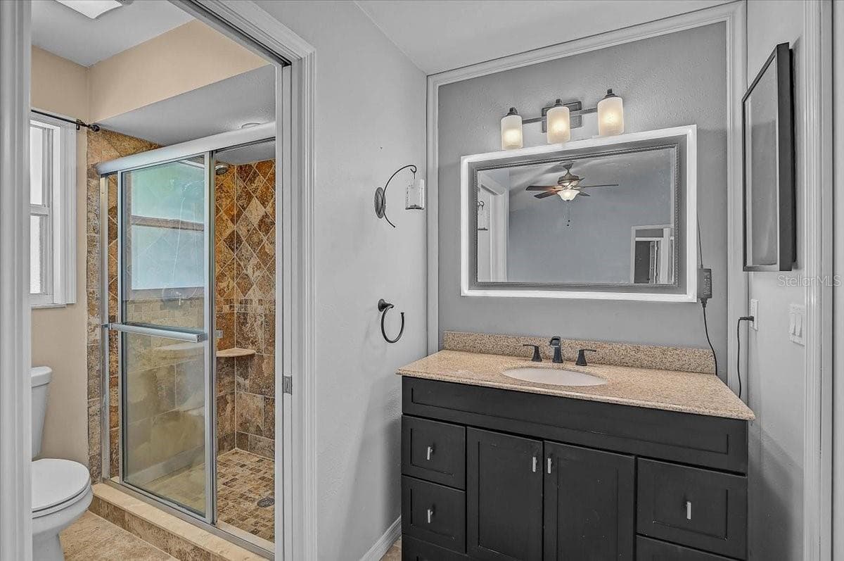 Primary Bathroom and Smart mirror custom color light frame. - 7739 33RD LN E, SARASOTA