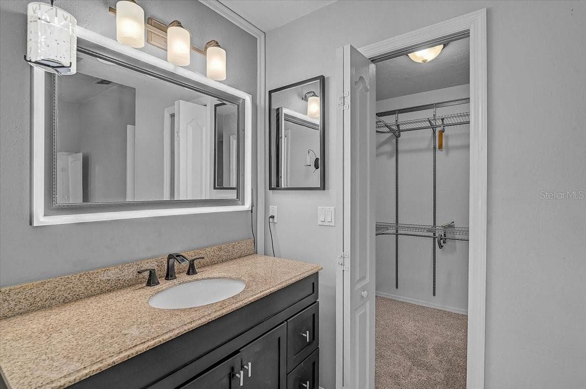 Smart mirror custom color light frame in primary bathroom and Walkin Closet. - 7739 33RD LN E, SARASOTA