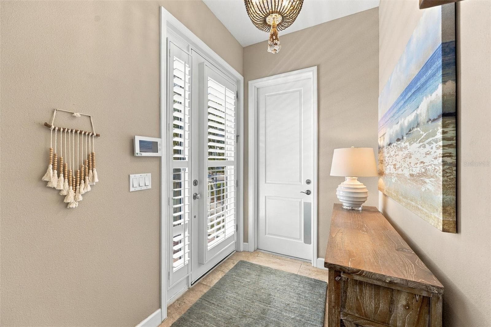 Welcome through the front entry, with convenient access to the second level by either stairs or elevator. - 291 COMPASS POINT DR #201, BRADENTON