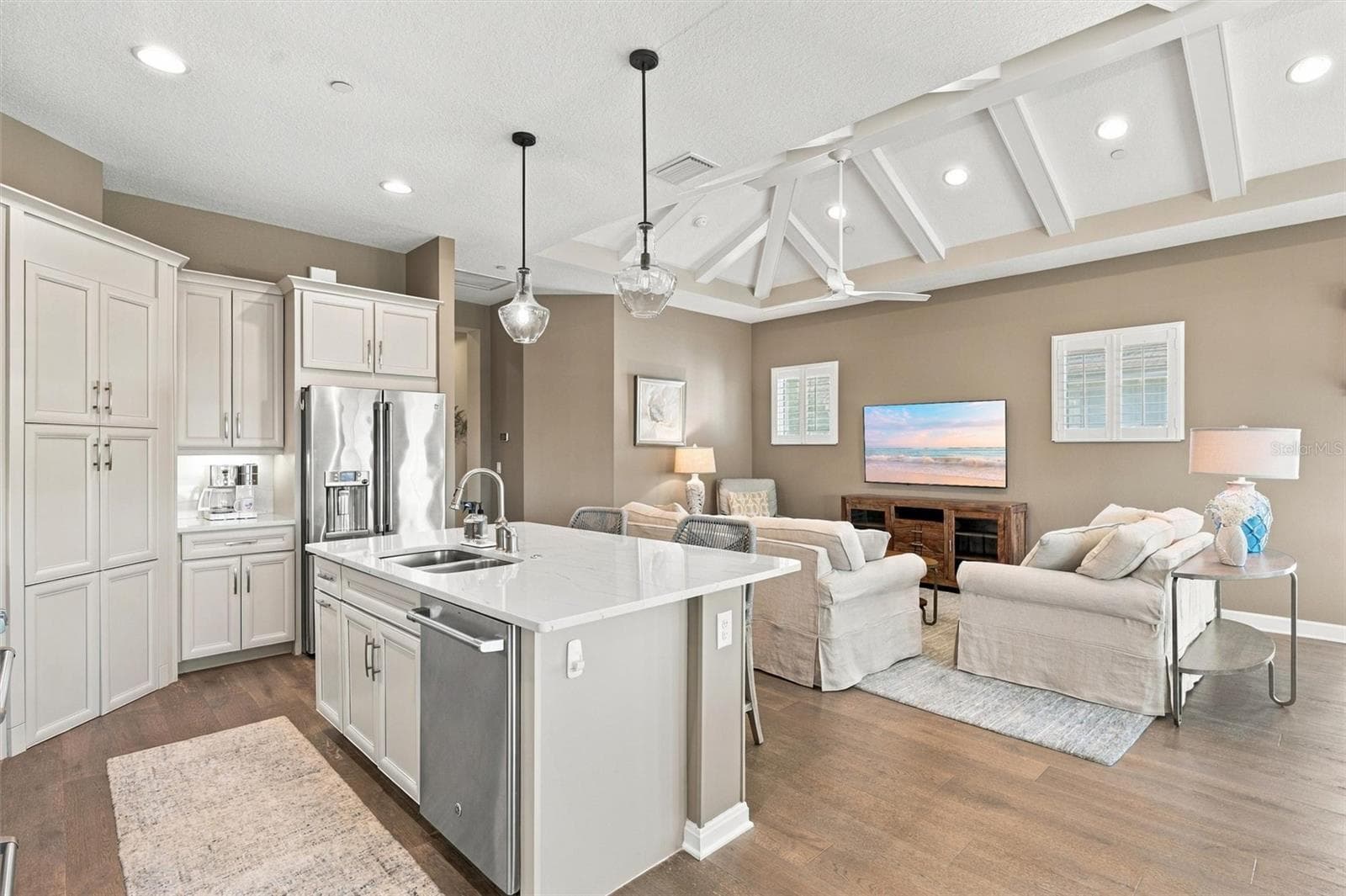 The well-designed kitchen shines with GE Café stainless steel appliances, elegant quartz countertops, and a spacious walk-in pantry. - 291 COMPASS POINT DR #201, BRADENTON
