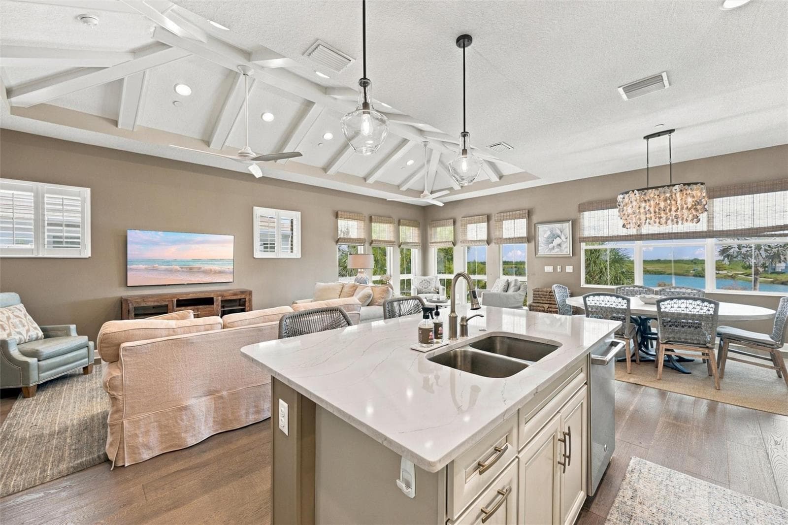 Enjoy peaceful Sapphire Lake views from this beautifully appointed home, featuring an open-concept floor plan, soaring vaulted ceilings, and Mohawk engineered hardwood flooring. - 291 COMPASS POINT DR #201, BRADENTON