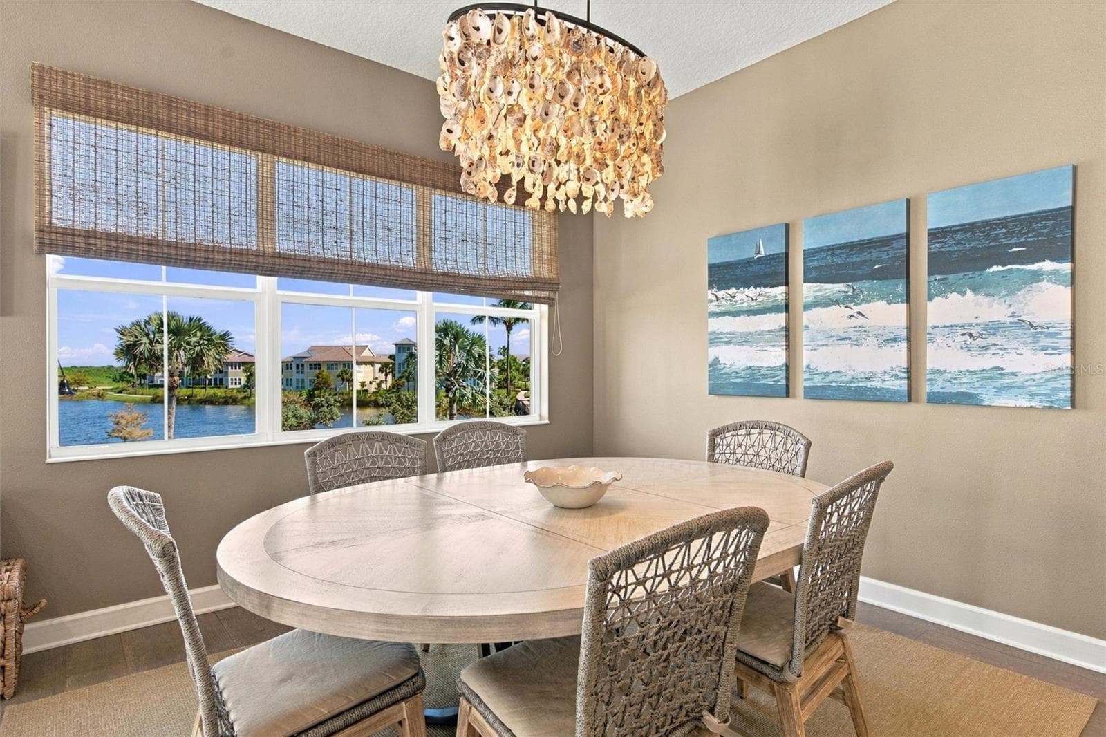 Enjoy peaceful Sapphire Lake views from this beautifully appointed home, featuring an open-concept floor plan, soaring vaulted ceilings, and Mohawk engineered hardwood flooring. - 291 COMPASS POINT DR #201, BRADENTON