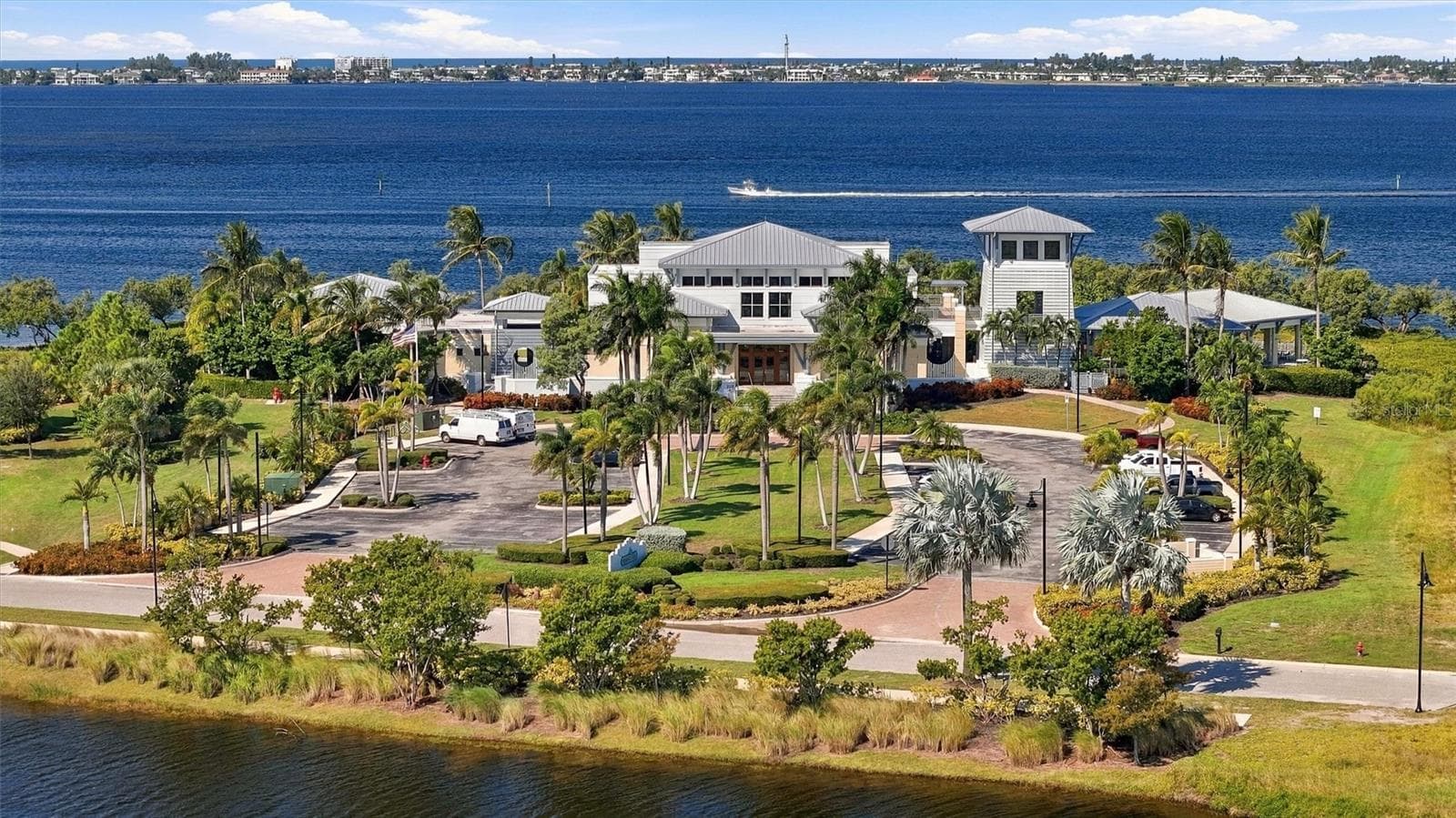 Enjoy an exceptional resort-style lifestyle with a 23,000-square-foot Beach Club, SkyBar lounge, heated resort pool and spa, private beach with kayak access to the Sound, and an impressive 4,200-square-foot fitness center. - 291 COMPASS POINT DR #201, BRADENTON
