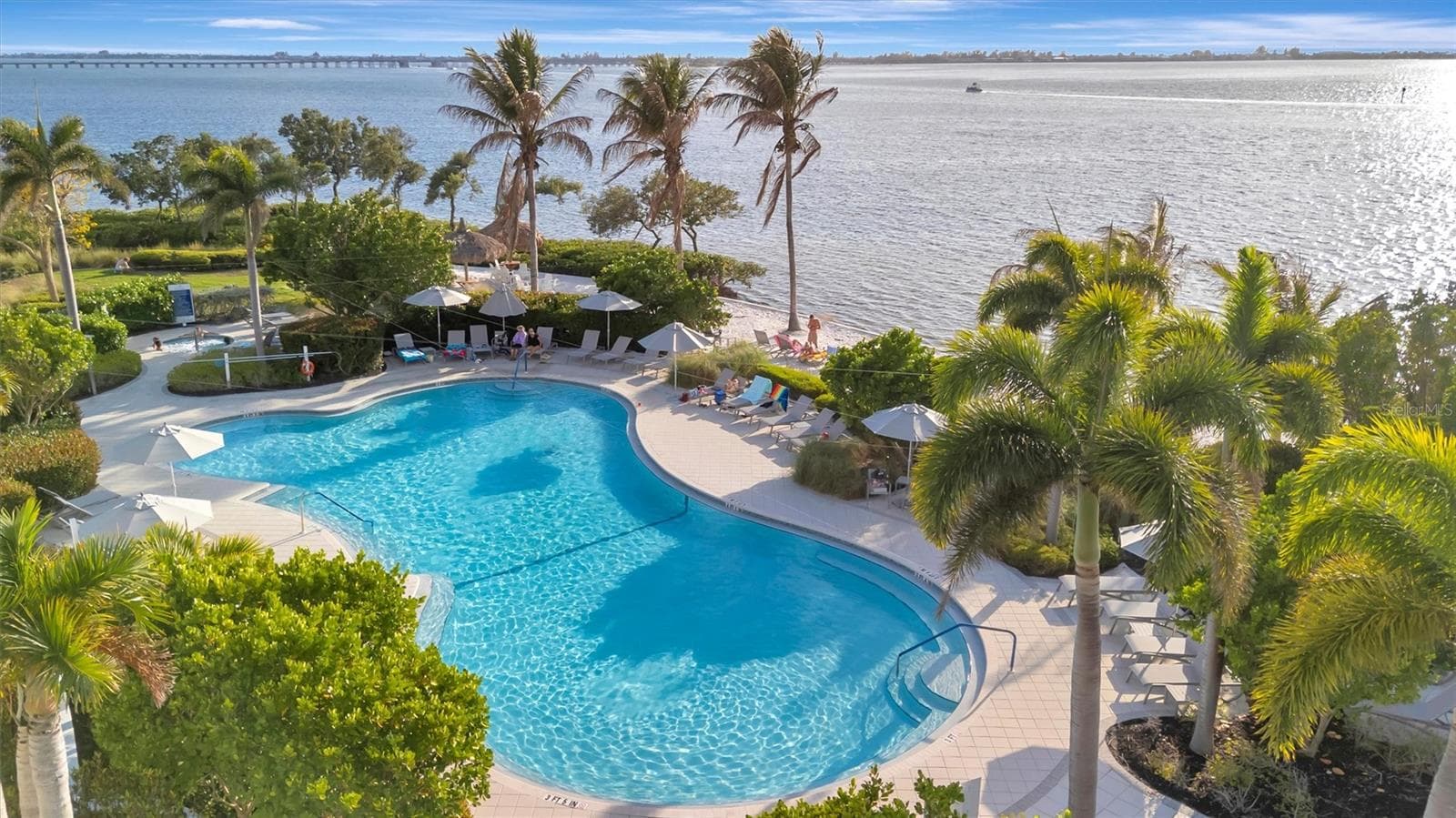 Enjoy an exceptional resort-style lifestyle with a 23,000-square-foot Beach Club, SkyBar lounge, heated resort pool and spa, private beach with kayak access to the Sound, and an impressive 4,200-square-foot fitness center. - 291 COMPASS POINT DR #201, BRADENTON
