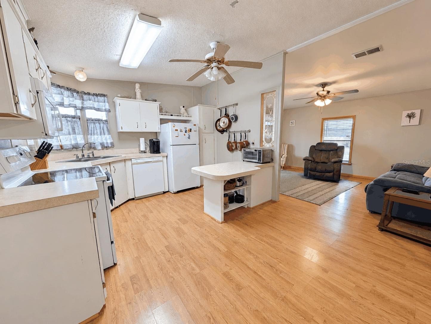 Kitchen and Living Room view from Dining Room - 6066 SE SOUTHERN OAKS DR, WINTER HAVEN
