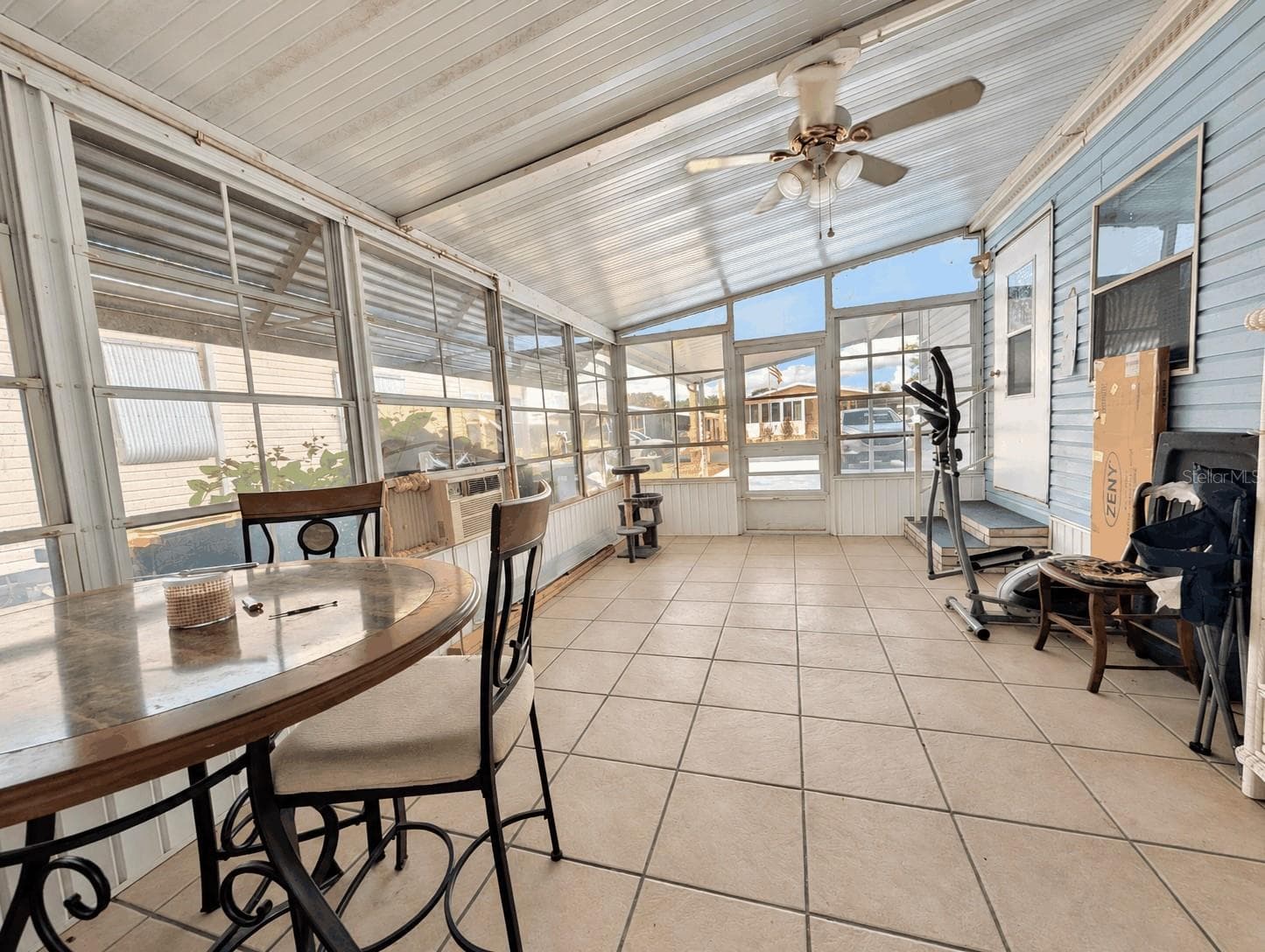 Side screened porch view from back storage room - 6066 SE SOUTHERN OAKS DR, WINTER HAVEN