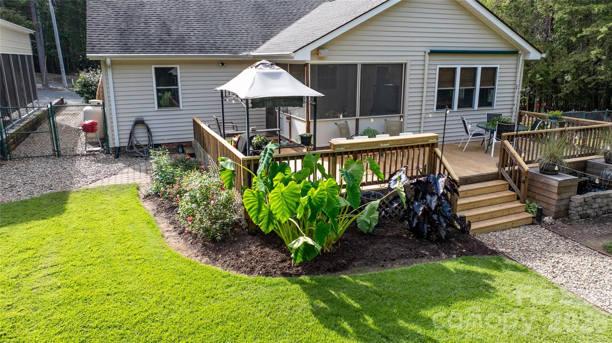 Entertainment deck covered grilling area and plenty of seating for guest, plus sounds and view from the water feature. - 571 Newport Drive, Mount Gilead