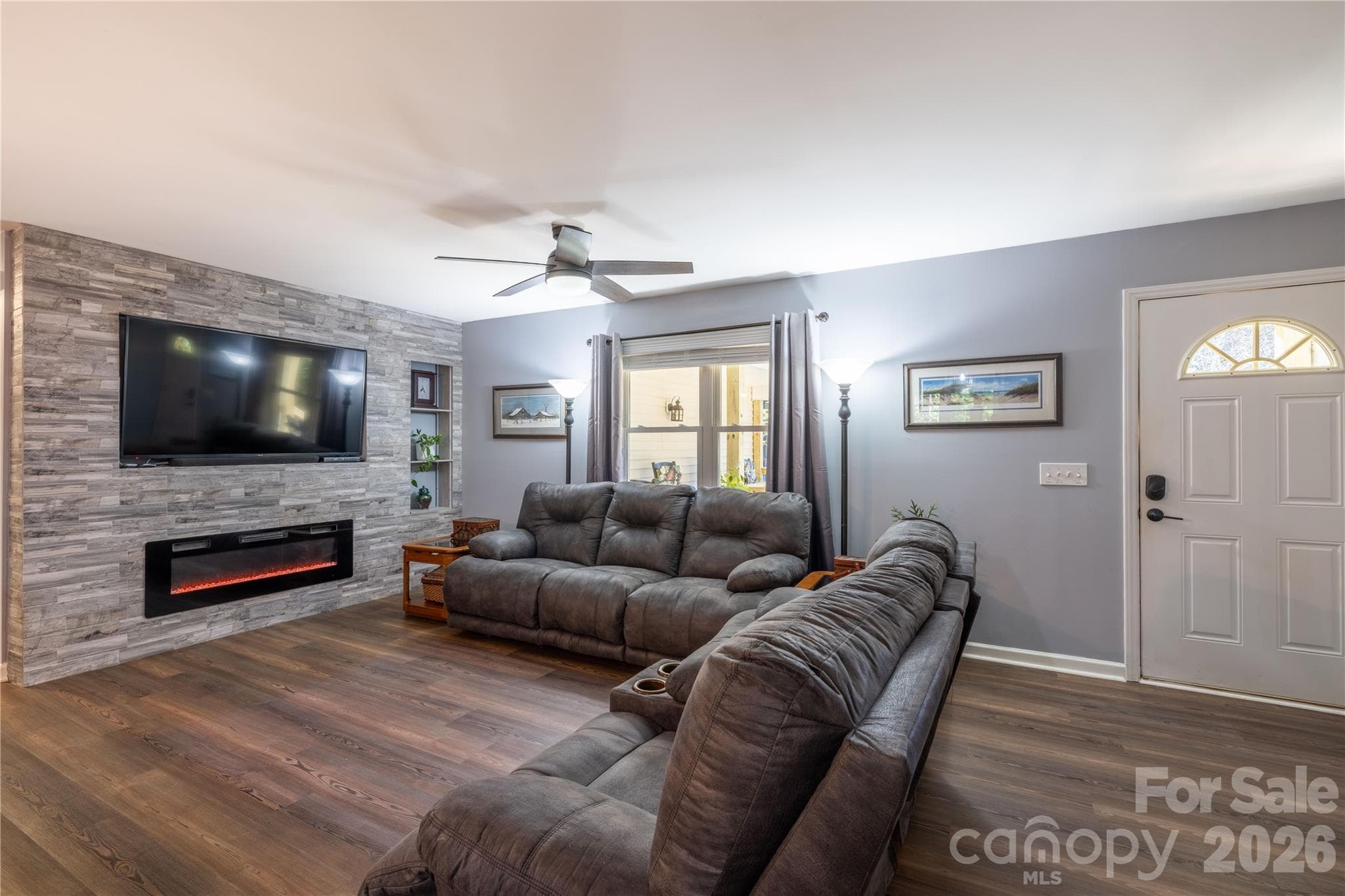 The TV & Electric Fireplace wall done in 2023 by owners is real stacked tile and tv will stay. - 571 Newport Drive, Mount Gilead