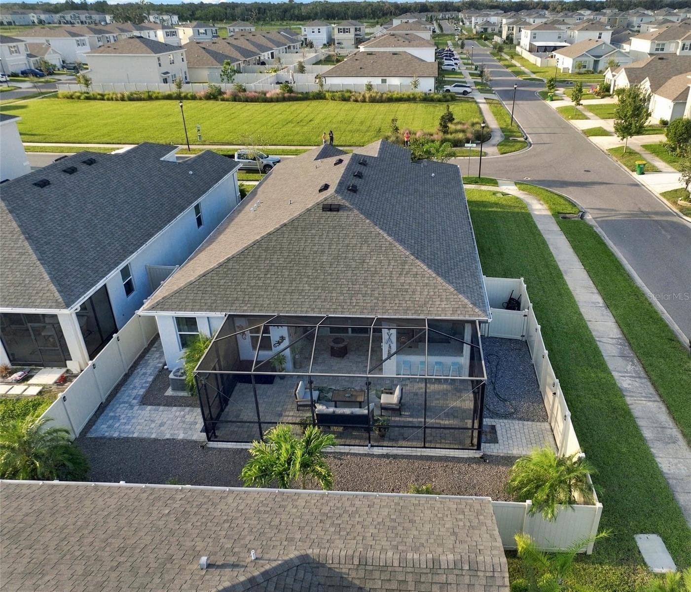 Rear View Showcasing the Home's Roofline and Outdoor Living Area - 33310 MAJOR OAK DR, WESLEY CHAPEL
