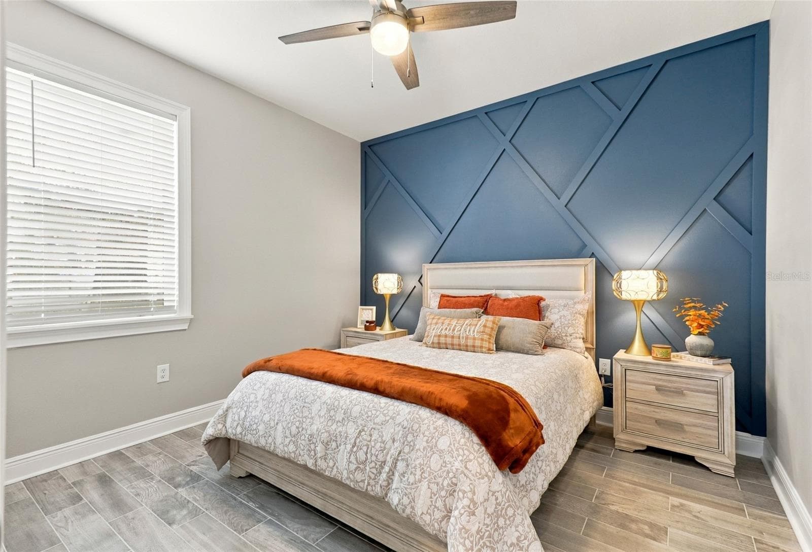 Bedroom Featuring a Decorative Blue Accent Wall and Tile Flooring - 33310 MAJOR OAK DR, WESLEY CHAPEL