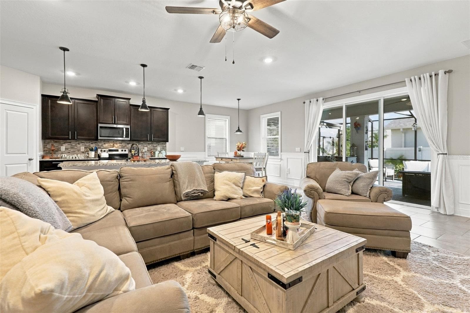 Living Area Flowing Seamlessly into Kitchen and Dining Spaces - 33310 MAJOR OAK DR, WESLEY CHAPEL