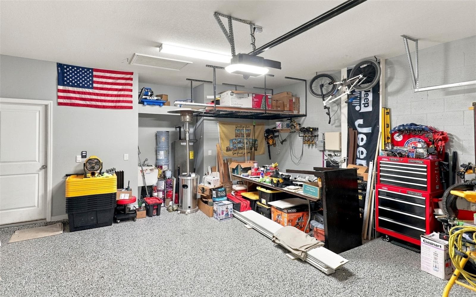 Garage Showcasing Epoxy-Coated Flooring and Ample Storage Space - 33310 MAJOR OAK DR, WESLEY CHAPEL