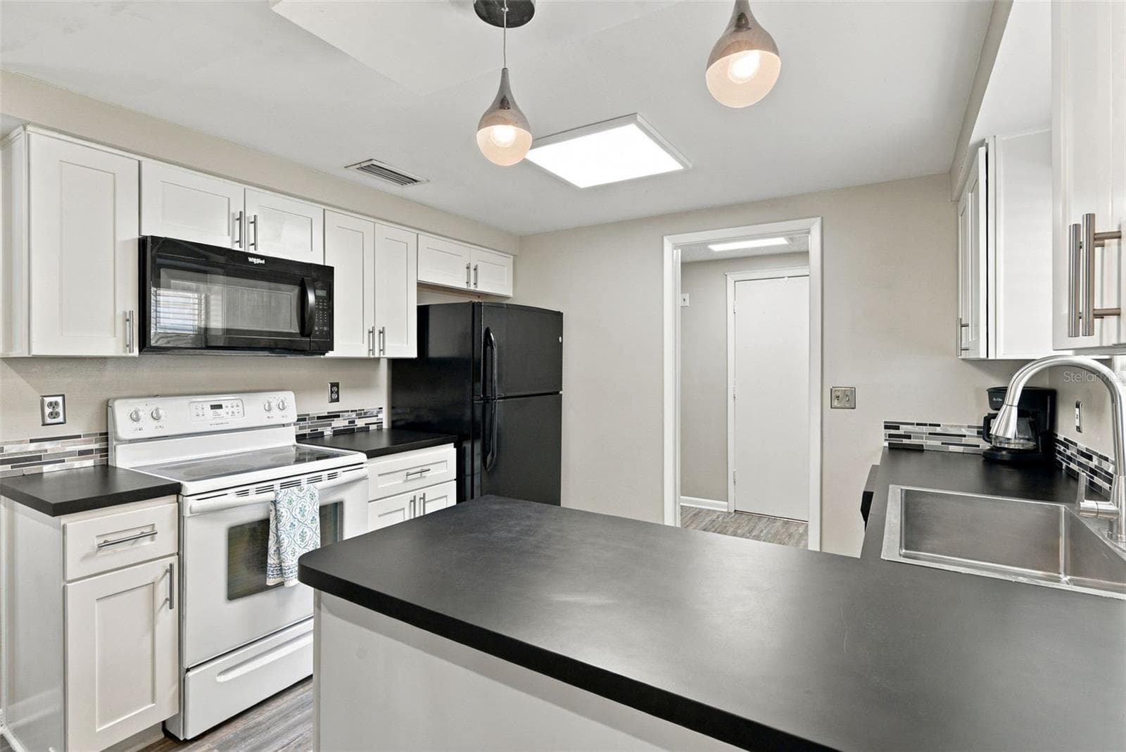 Another view of kitchen - 2022 microwave - 16136 FOXFIRE DR, TAMPA