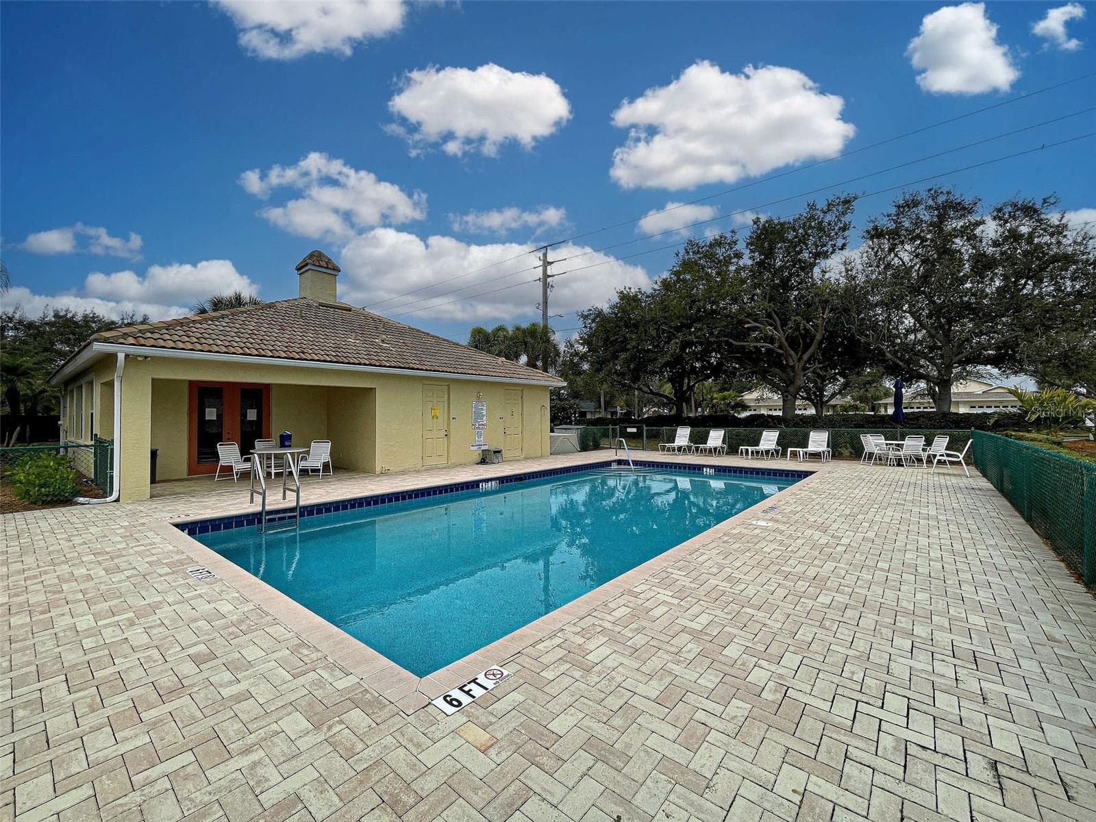 There is a large deck with pavers around the co9mmunity pool. - 251 VISTA DEL LAGO WAY, VENICE