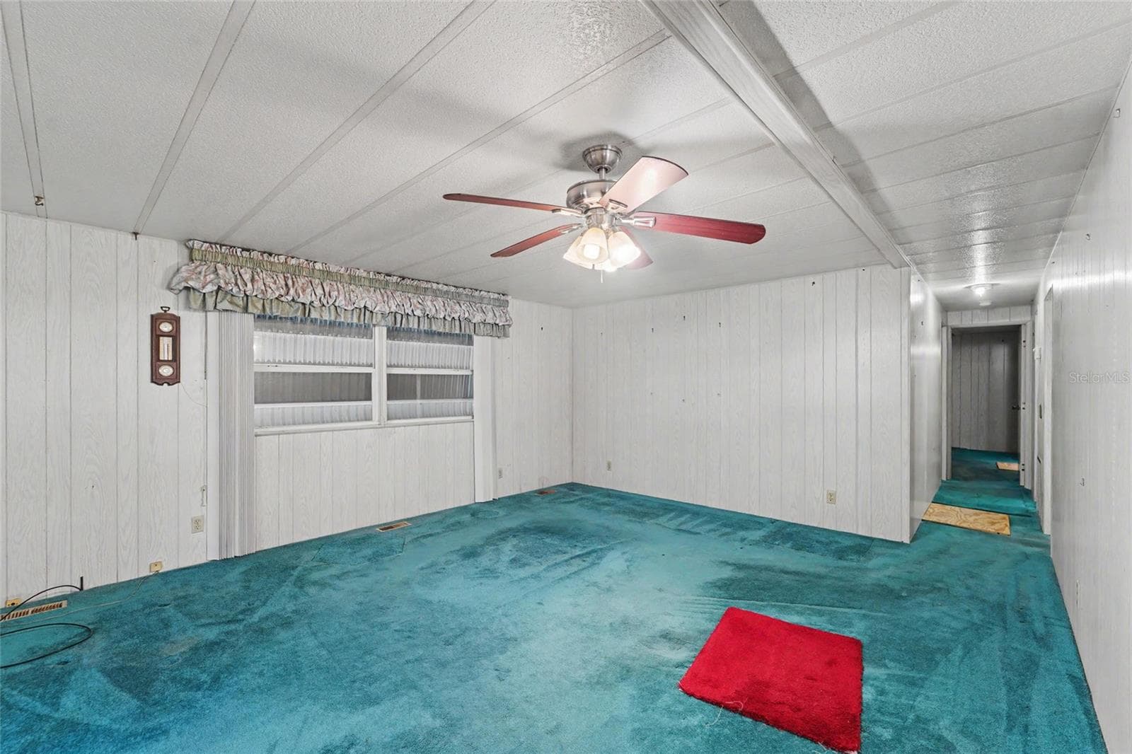 Large Living area - hurricane shutters are down and seen through the windows - 1500 COUNTY ROAD 1 #219, DUNEDIN
