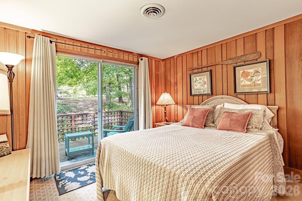 Second bedroom on upper level with private balcony - 208 N West Lake Drive, Lake Lure