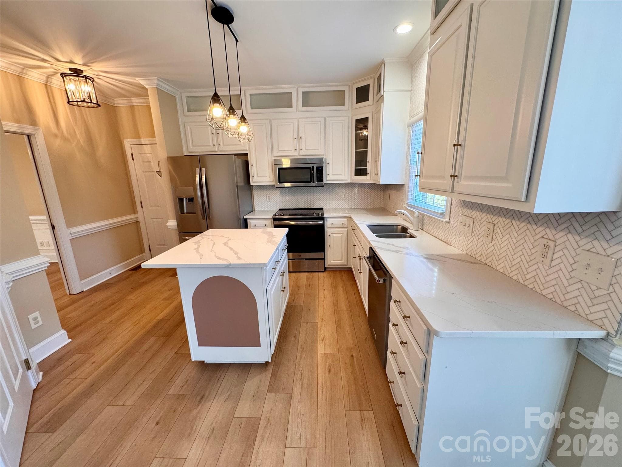 Renovated kitchen with quartz countertops and marble tile backsplash. Stainless appliances convey. - 7101 Founders Way, Harris