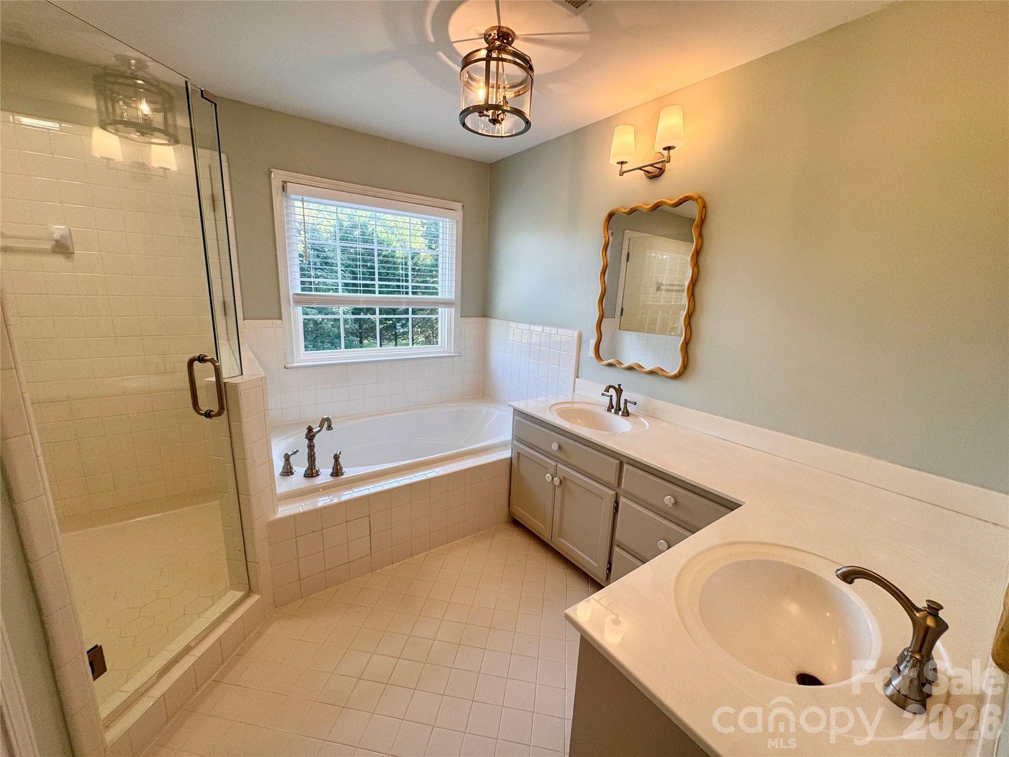 Primary Bathroom with walk in tiled shower, double vanity with lots of countertop space, and separate water closet. - 7101 Founders Way, Harris