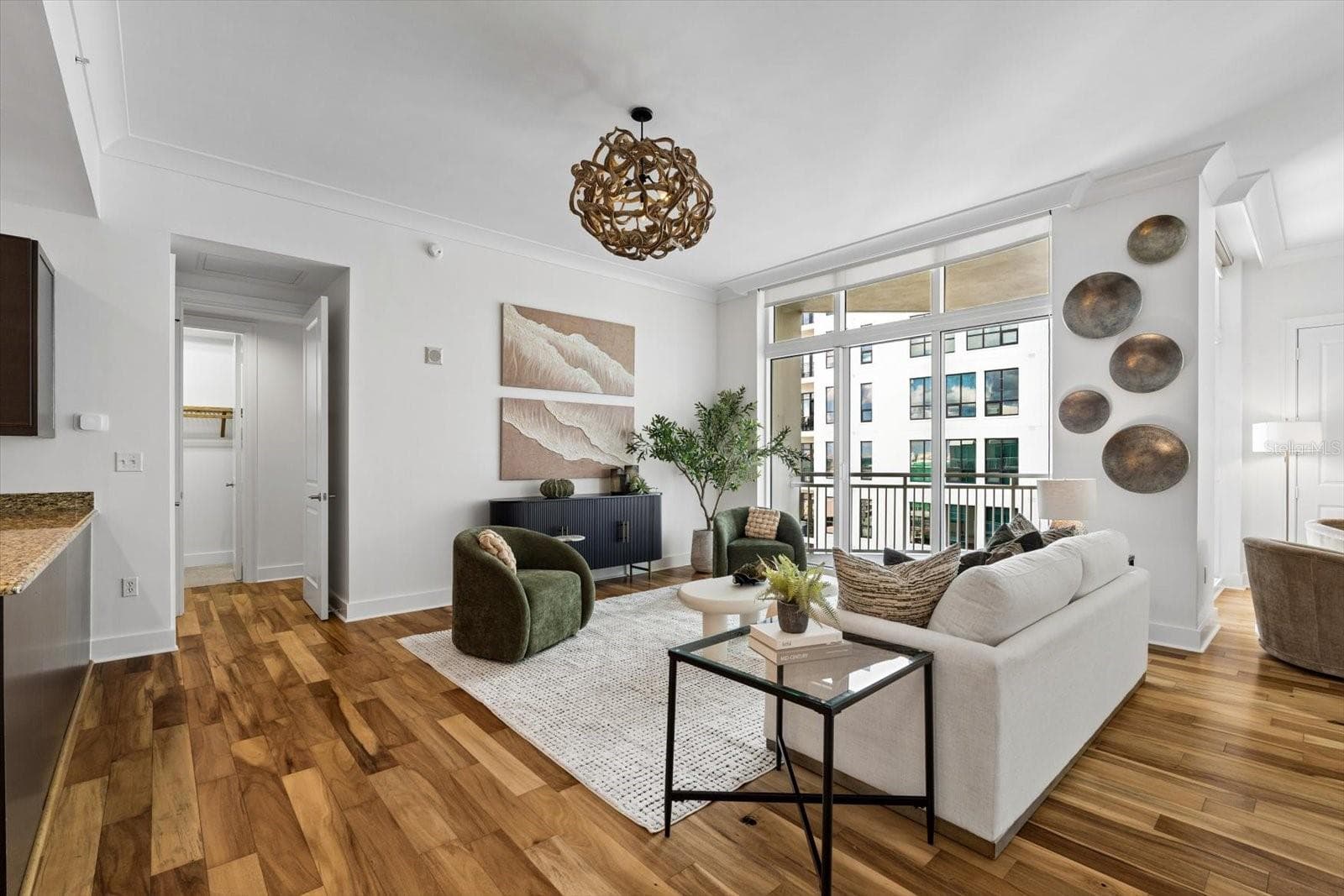 Living room with tall sliders out to a covered balcony - 1350 MAIN ST #1703, SARASOTA