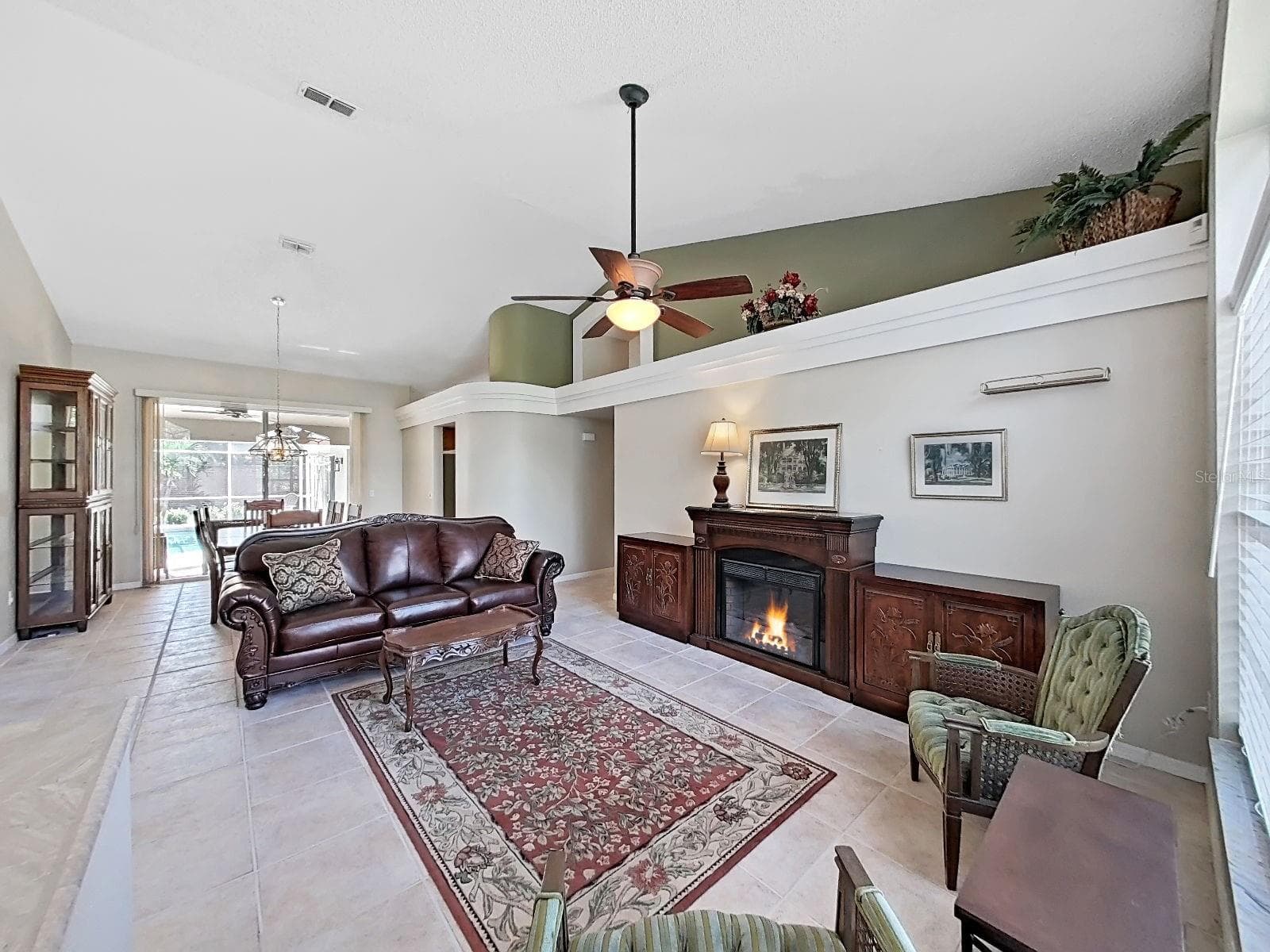 view front door: living and dining rooms, view of covered patio and screened-in pool - 15001 MEADOWLAKE ST, ODESSA