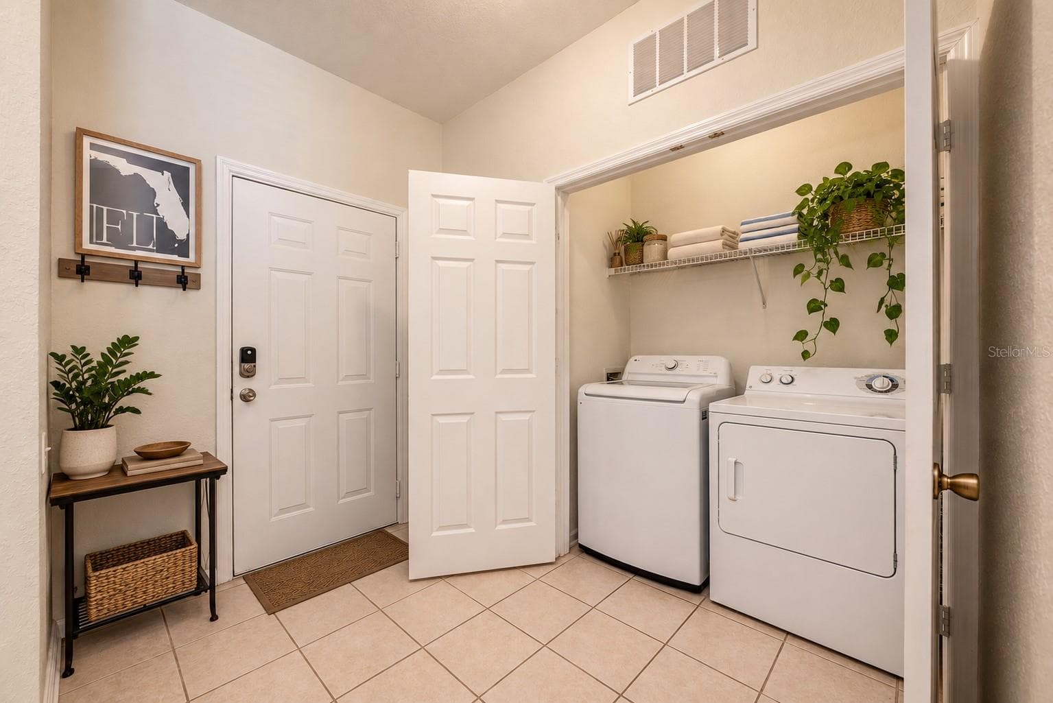 Welcoming ENTRY greet guests, and includes a charming Laundry closet fitted with washer and dryer. - 2778 ALMATON LOOP #204, KISSIMMEE