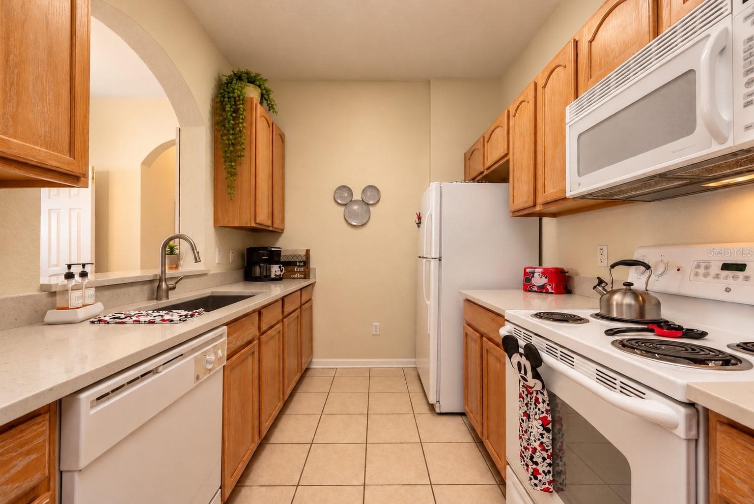 All ages can appreciate the many "winks" to Mickey throughout this neutral clean kitchen. - 2778 ALMATON LOOP #204, KISSIMMEE