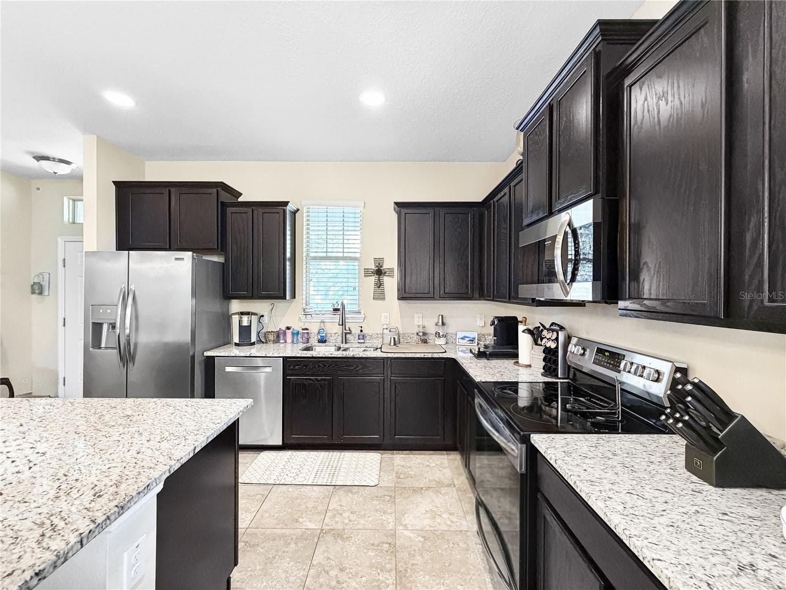 Classic espresso cabinetry, granite counters and stainless appliances - 9662 WATERWAY PASSAGE DR, WINTER GARDEN