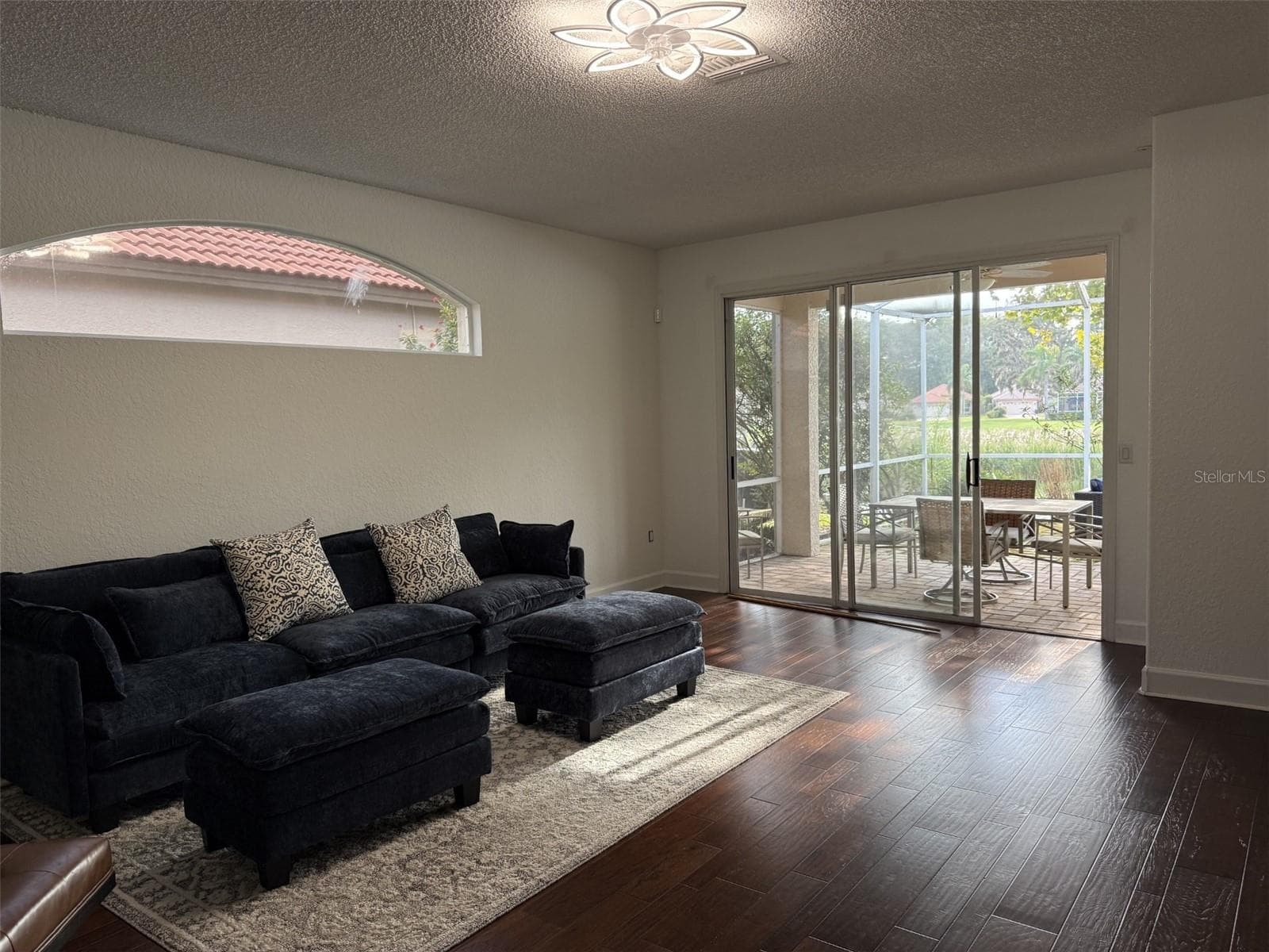 Freshly painted living room with sliders to lanai - 1338 DARTFORD DR, TARPON SPRINGS