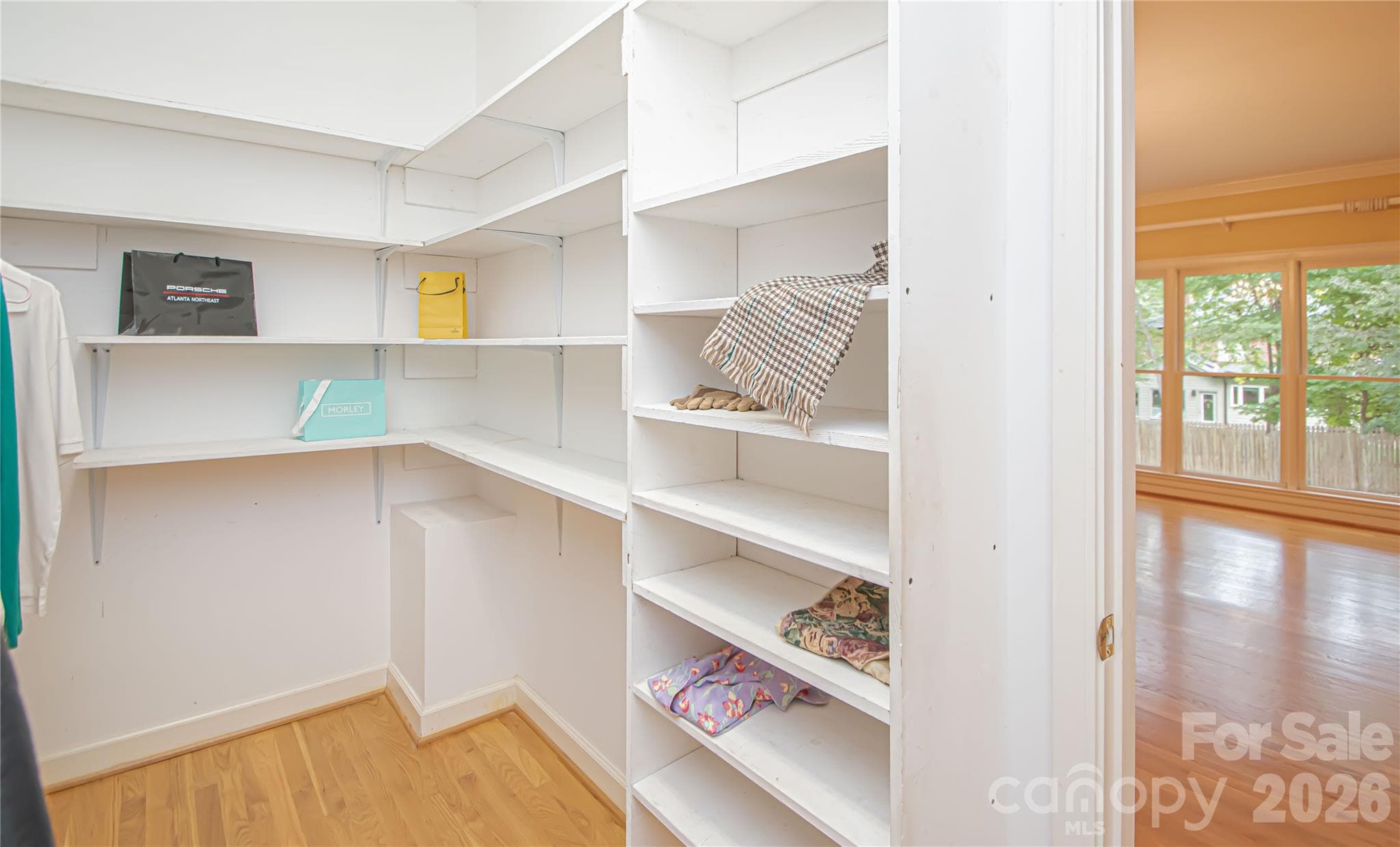 Primary Bedroom WALK IN CLOSET 10'x6' with built in wood shelves. - 5480 Glen Forest Drive, Charlotte