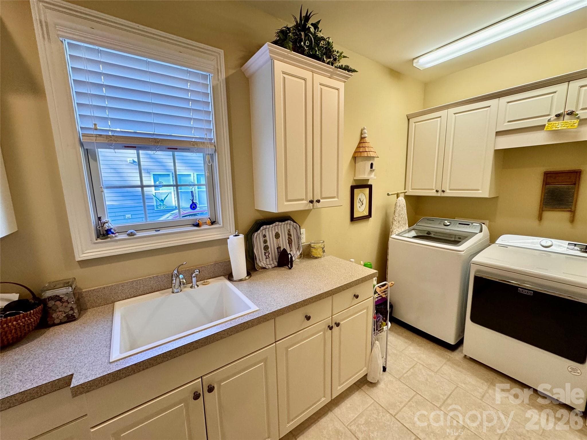 Laundry sink, closet, cabinetry for storage and washer/dryer convey - 2909 Donegal Drive, Kannapolis