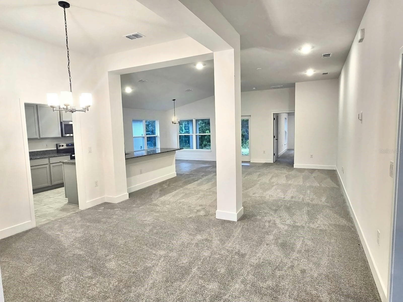 Foyer and dining room view to great room - 7678 BENT TREE LOOP, HARMONY