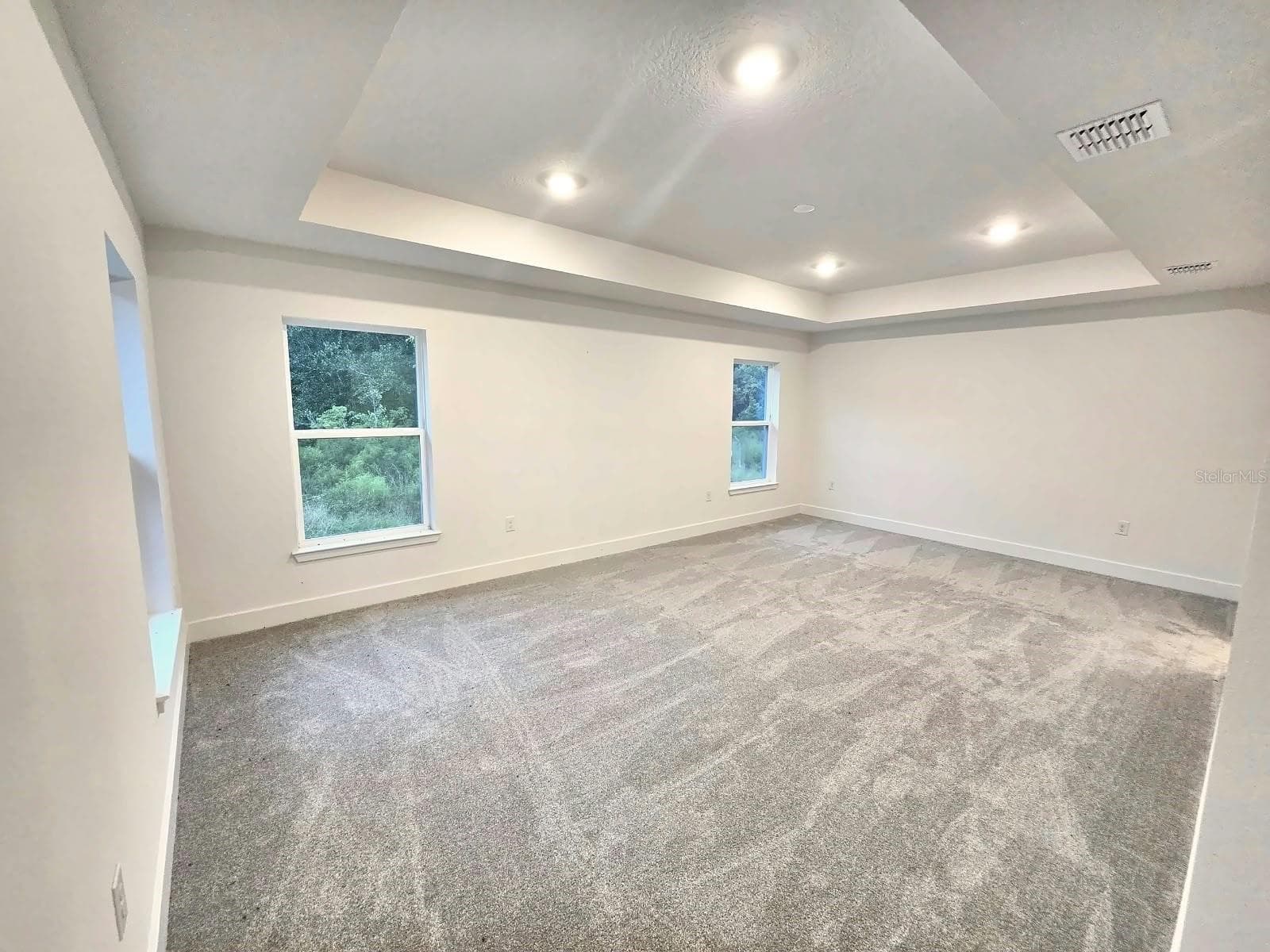 Primary bedroom with tray ceiling - 7678 BENT TREE LOOP, HARMONY