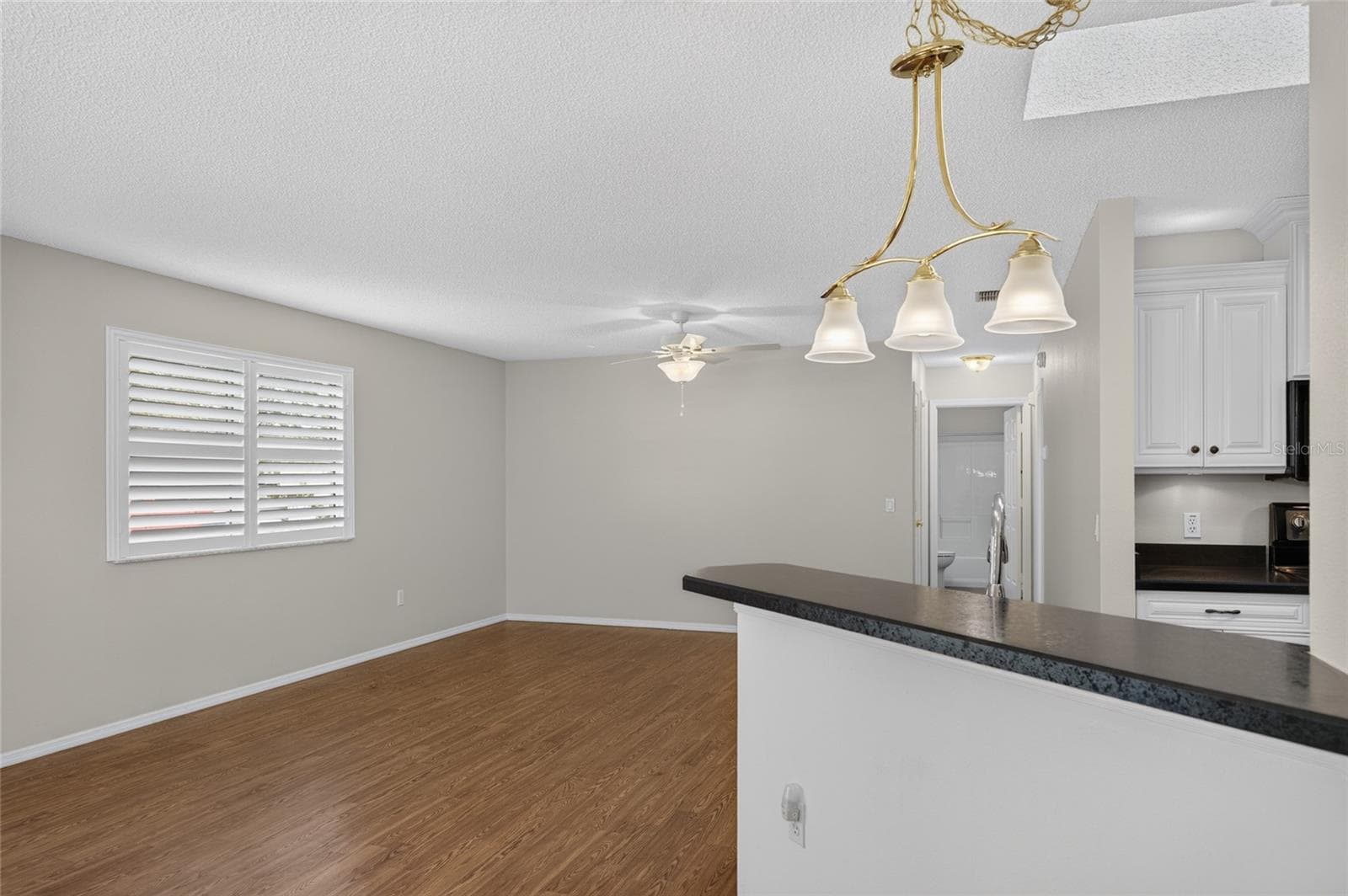 KITCHEN - Raised counter overlooks the adjoining living area. - 2124 ESCOBAR AVE, THE VILLAGES