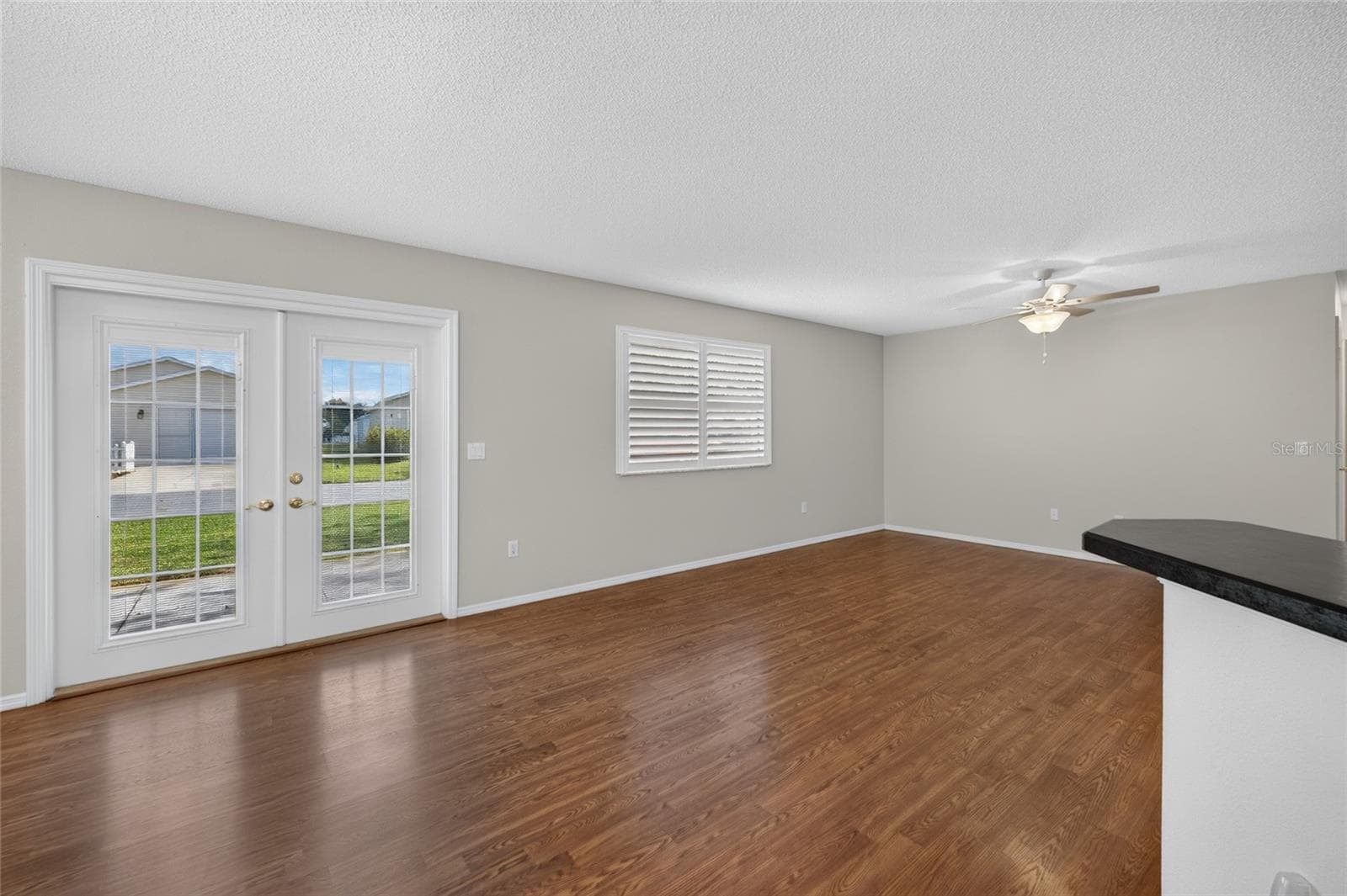 DINING/LIVING ROOMS - Freshly painted walls in a neutral palette provide a simple backdrop for the main living space. - 2124 ESCOBAR AVE, THE VILLAGES