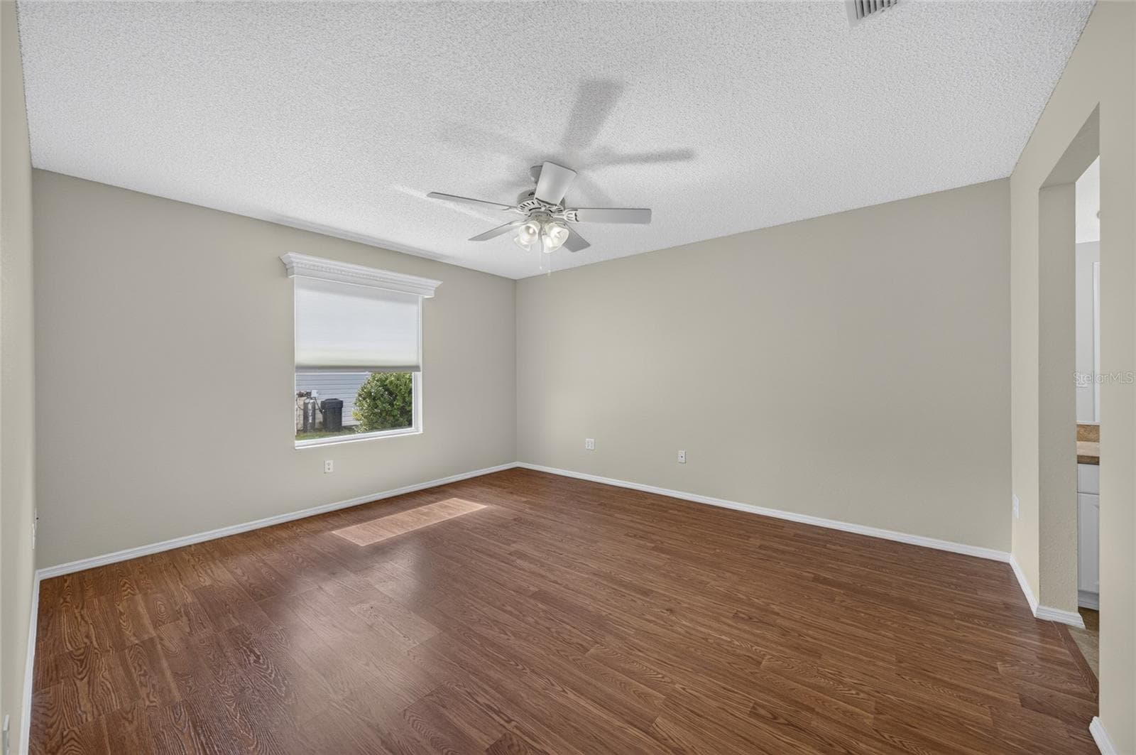 PRIMARY BEDROOM view from the doorway - Note white wooden window cornice and ceiling fan with light. - 2124 ESCOBAR AVE, THE VILLAGES