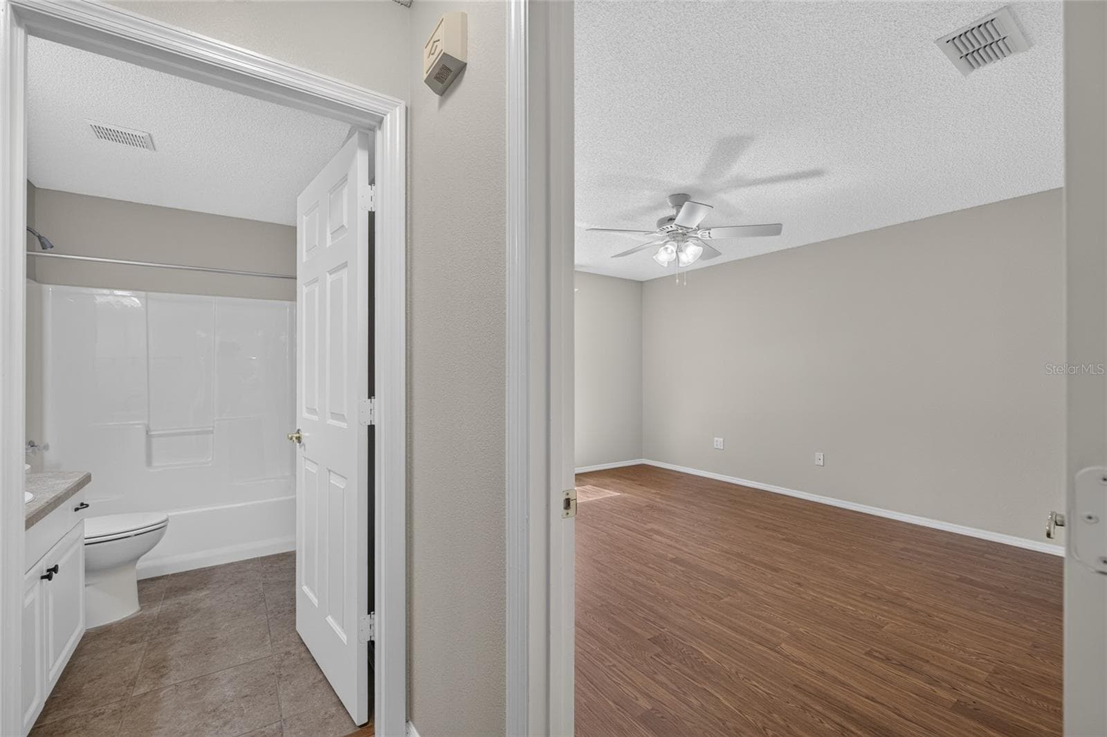 View of HALLWAY to rear of villa - PRIMARY BEDROOM doorway (R) and BATHROOM #2 doorway (L). - 2124 ESCOBAR AVE, THE VILLAGES