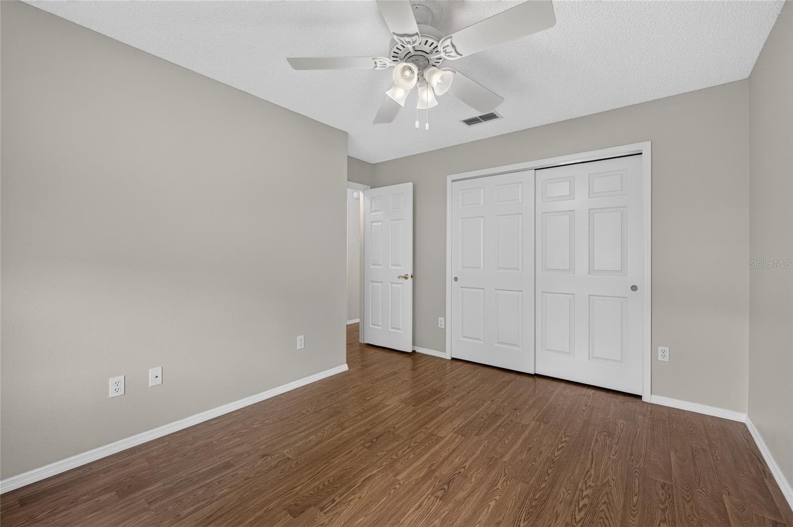 BEDROOM #2 - View along the closet wall toward the hallway doorway (far L). - 2124 ESCOBAR AVE, THE VILLAGES