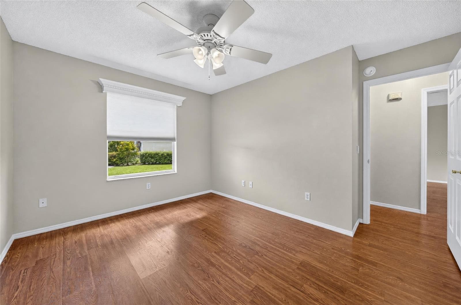 Another view of BEDROOM #2 - Shows white wooden window cornice and a ceiling fan with light. Note doorway (R) that shows connection to HALLWAY and main living area. - 2124 ESCOBAR AVE, THE VILLAGES