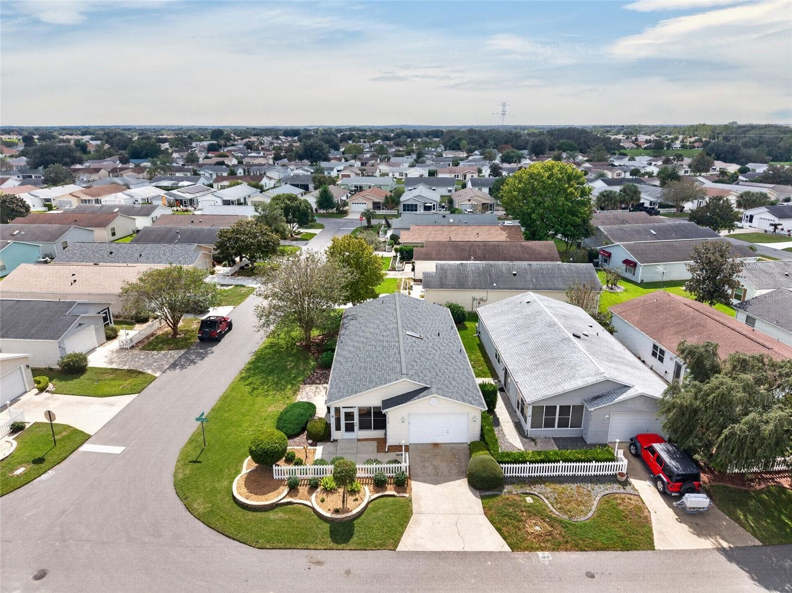 AERIAL / EXTERIOR - View of the villa, driveway and landscaping within the surrounding residential streets. - 2124 ESCOBAR AVE, THE VILLAGES