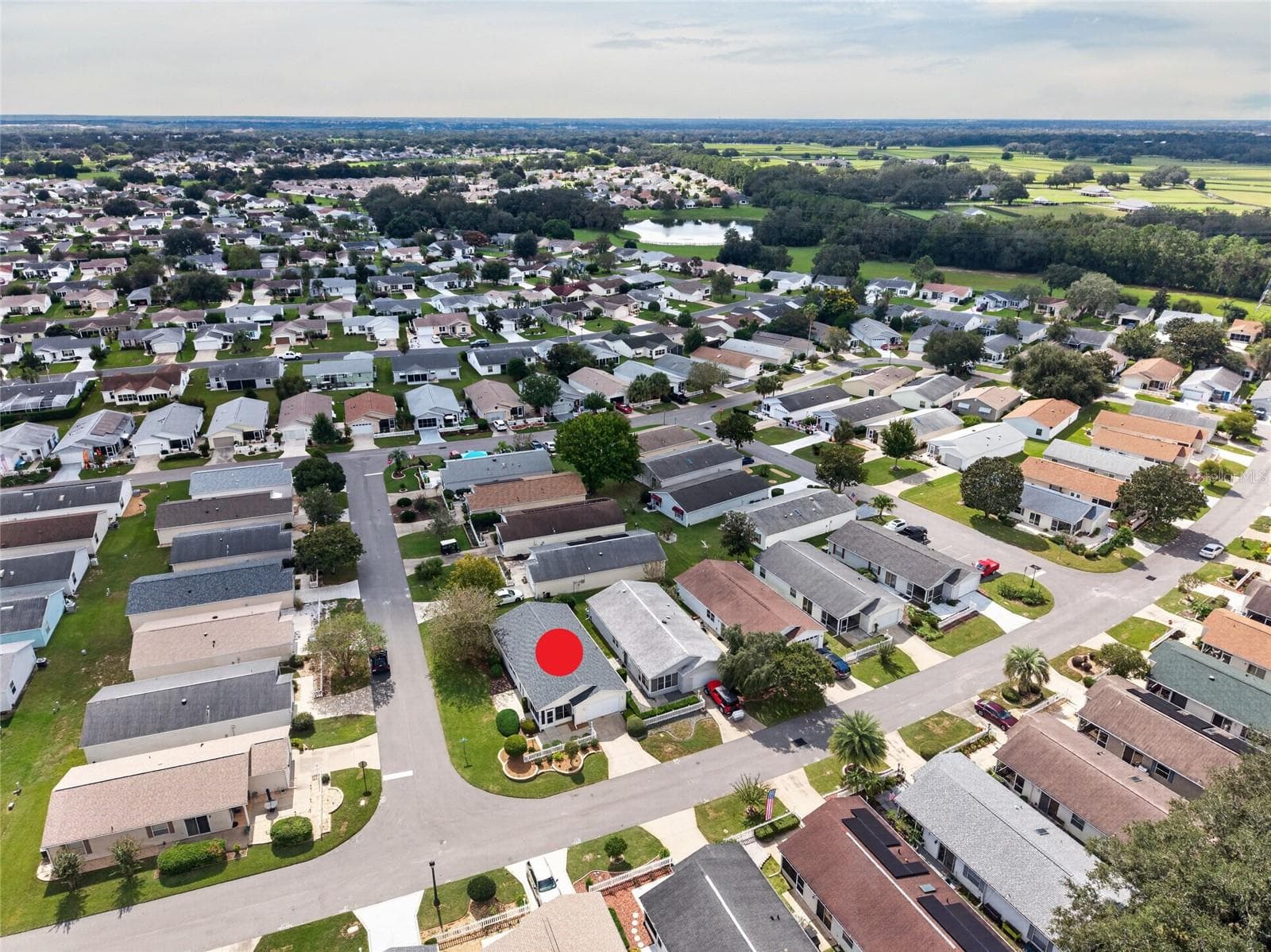 AERIAL – Looking Southwest – Patio villas here put their lanais and patios up front, facing the street, designed with community in mind, with convenient guest parking (right center) one street over. - 2124 ESCOBAR AVE, THE VILLAGES