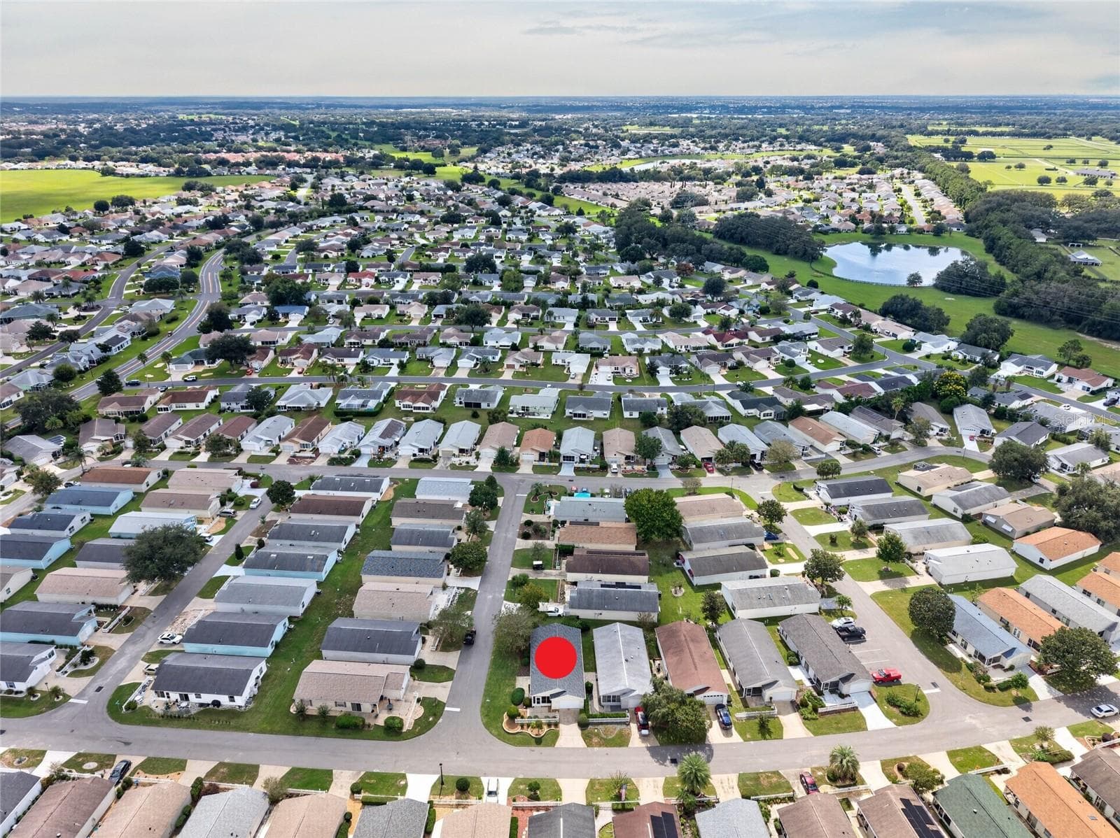 AERIAL – Looking South – CORNER LOT villa (marked) in SANTO DOMINGO, with Cazares Avenue (left), the Sharon L. Morse Owl Preserve (deep left) and golf-cart access to Lake Sumter Landing (deep center). - 2124 ESCOBAR AVE, THE VILLAGES