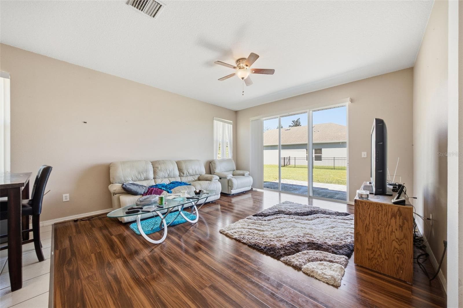 Family room with sliding glass doors to rear patio and yard - 10328 CELTIC ASH DR, RUSKIN