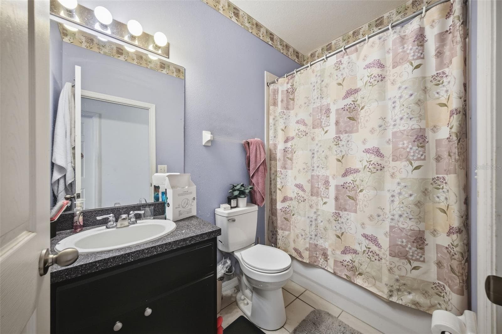 Hall bath with single vanity, tub/shower combo and tile floor - 10328 CELTIC ASH DR, RUSKIN