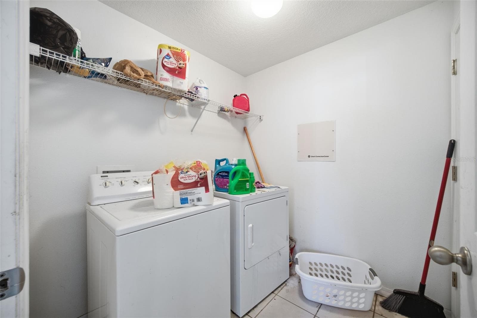 Indoor laundry room 7'0" x 6'7" with washer, dryer and wire shelving - 10328 CELTIC ASH DR, RUSKIN