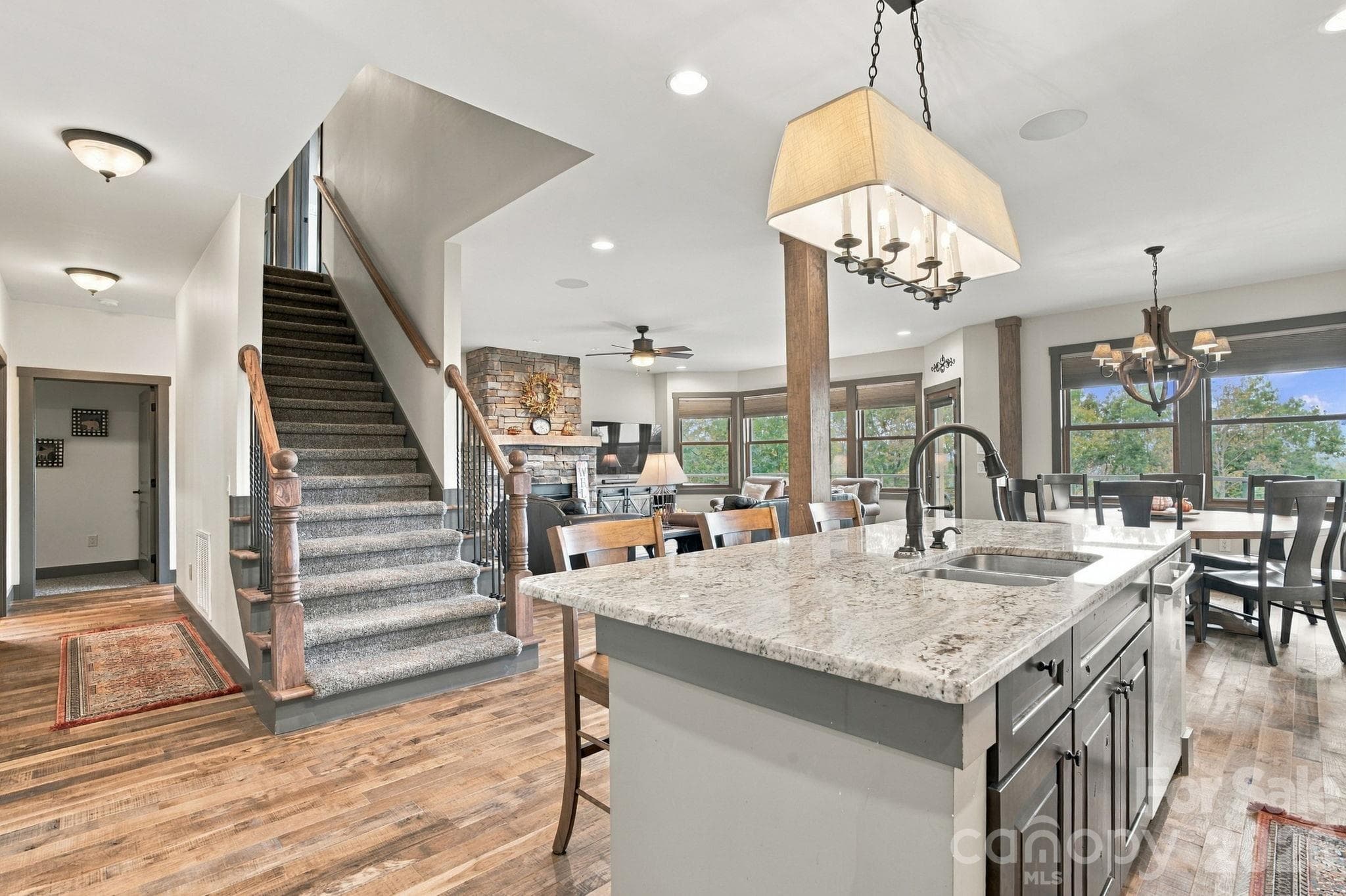 Entry way open floor plan with beautiful hardwood floors and kitchen bar area with stools - 1206 River Stone Drive, Laurel Springs