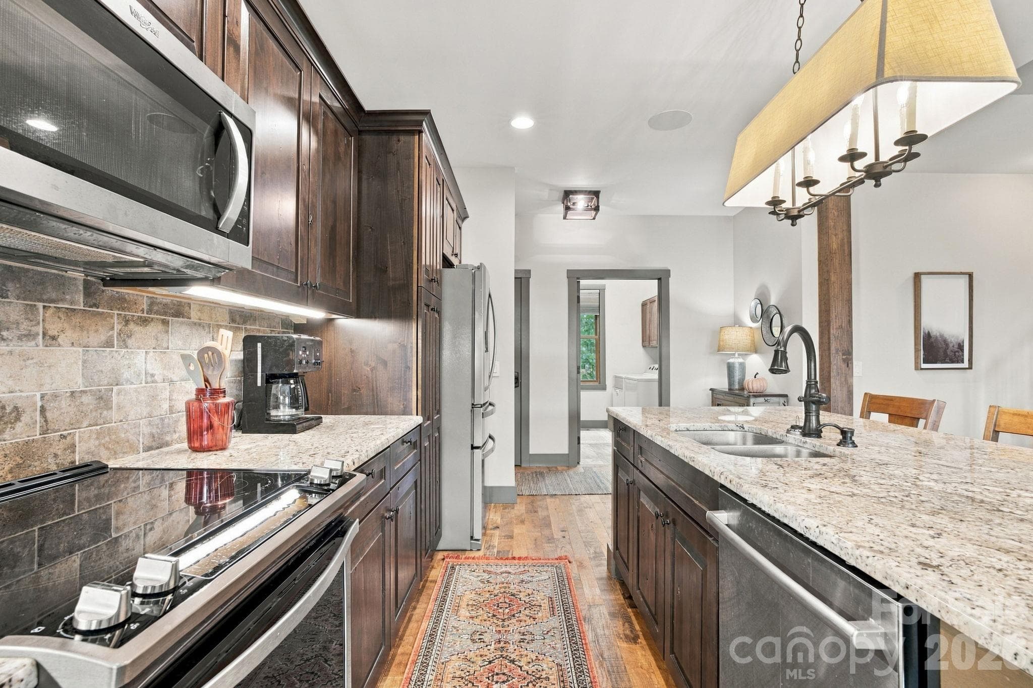 Kitchen with refrigerator, electric stove/oven, dishwasher and microwave - 1206 River Stone Drive, Laurel Springs