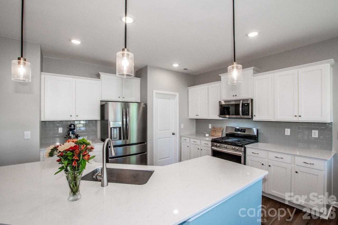 The Kitchen has a spacious Island with stylish pendant lights above - 1944 Lowland Shade Court, Maiden