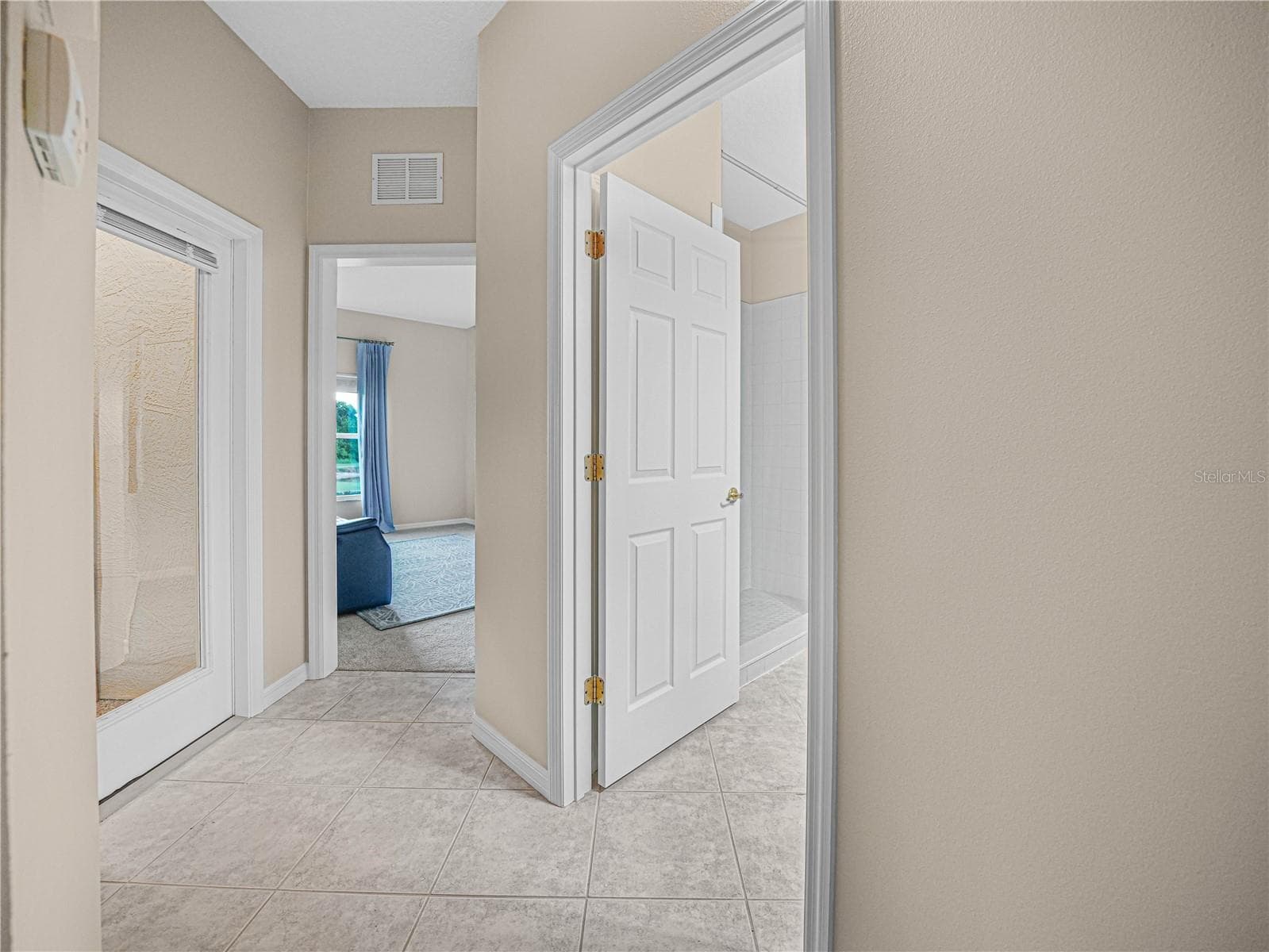 Tiled Hallway to the Guest Bath, Bed 3 and Covered Florida Room - 4299 ASHTON CLUB DR, LAKE WALES
