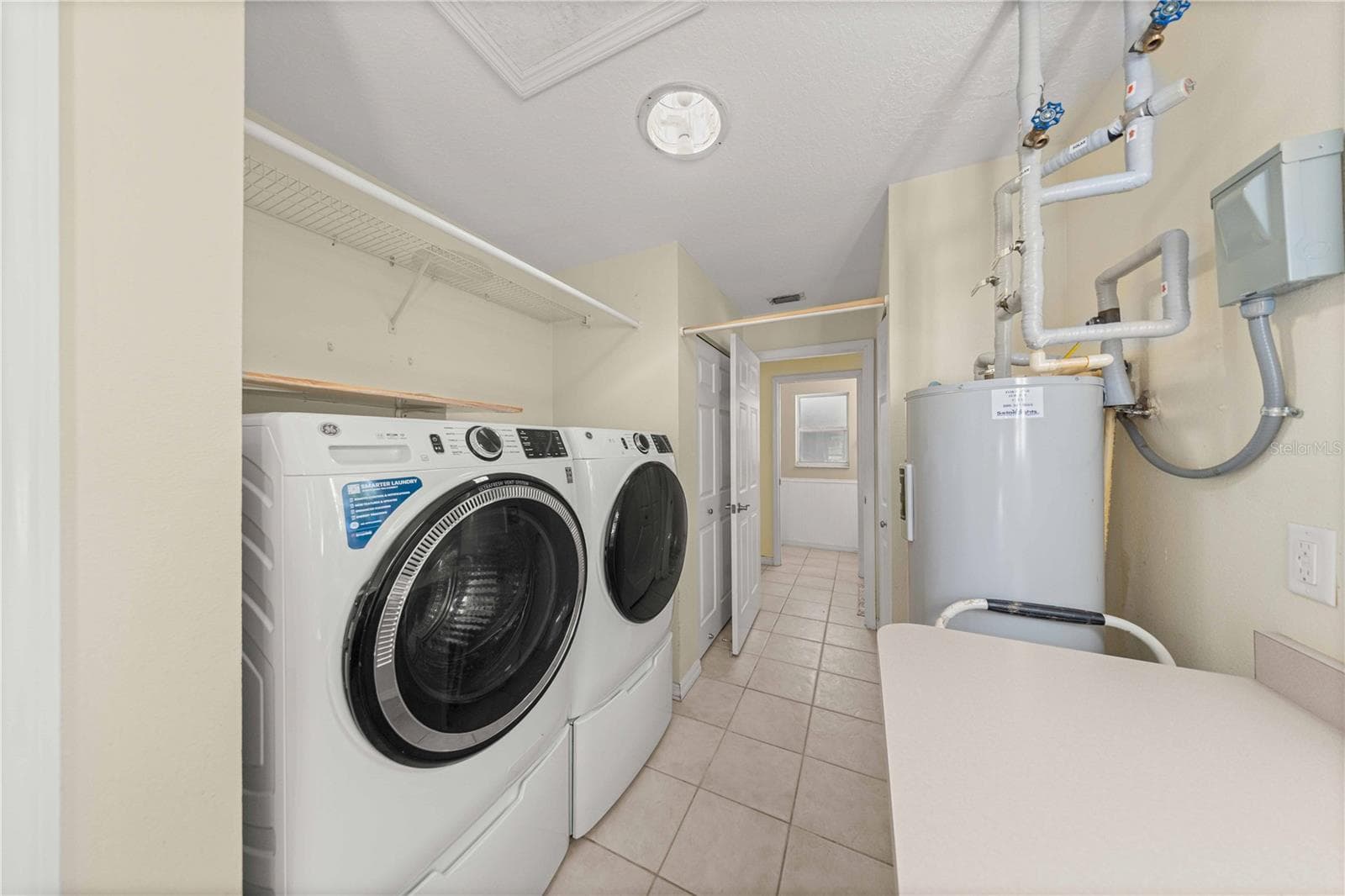Laundry room with pantry and storage closet - 7156 NW 11TH ST, OCALA